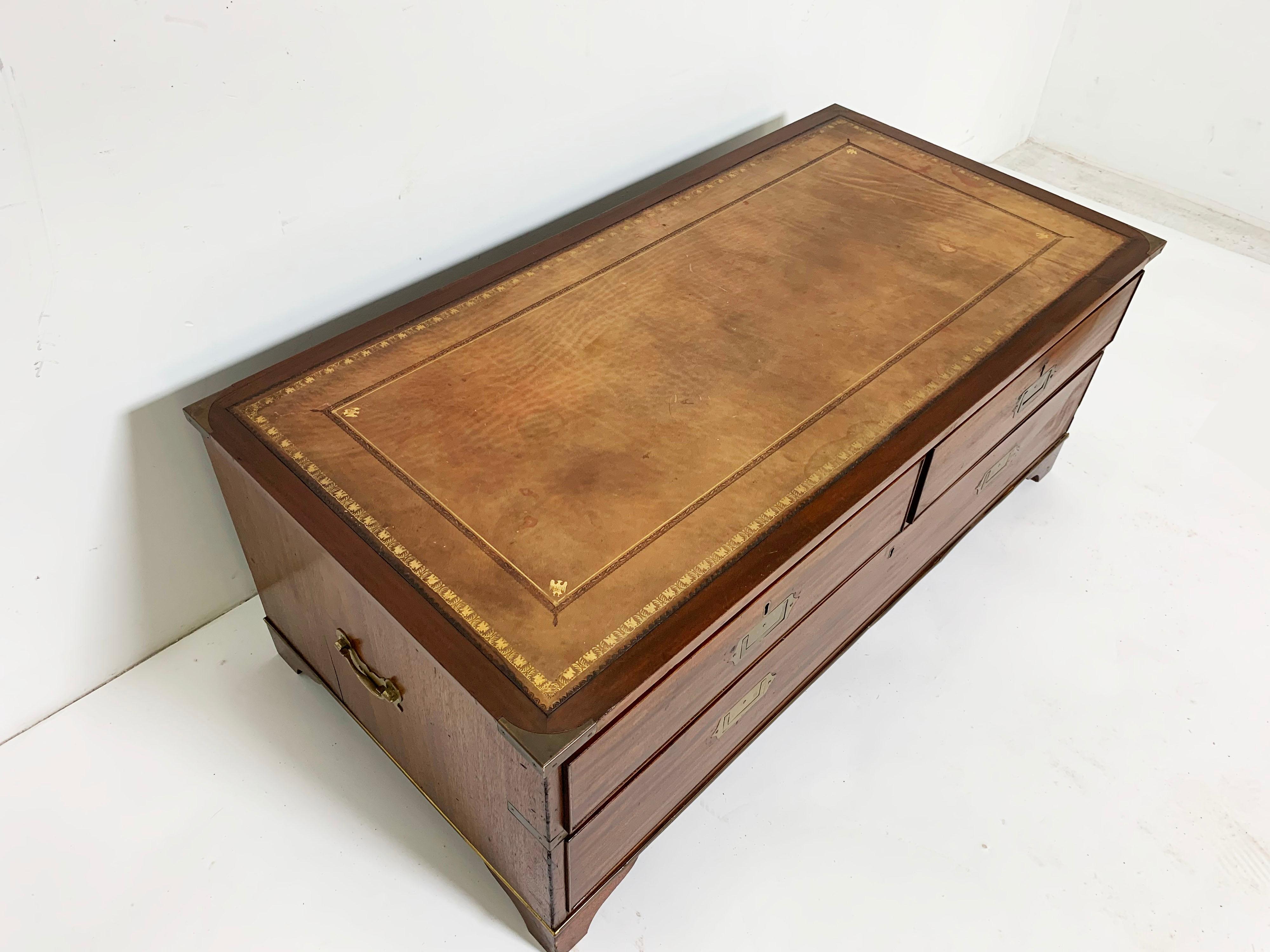 An antique British map chest coffee table in solid mahogany with leather top, circa late 19th-early 20th century.

