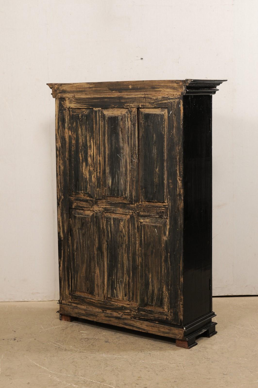 Antique British Colonial Black Armoire Cabinet with Raised Oval-Panel Doors In Good Condition For Sale In Atlanta, GA