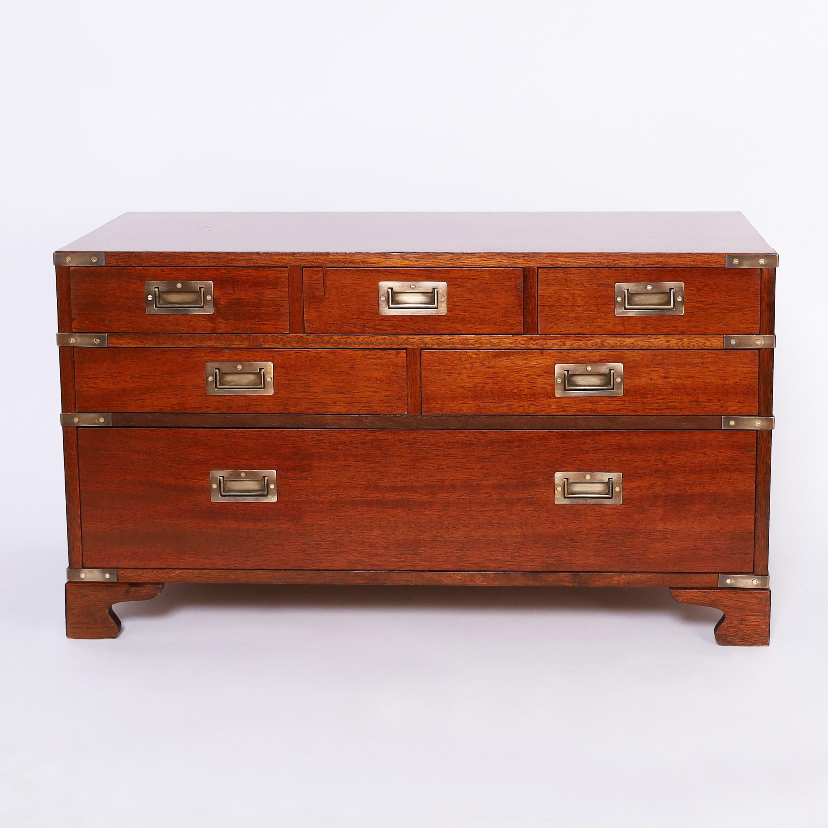 Handsome British Colonial chest crafted in mahogany with six drawers in a low profile with brass campaign hardware and bracket feet.