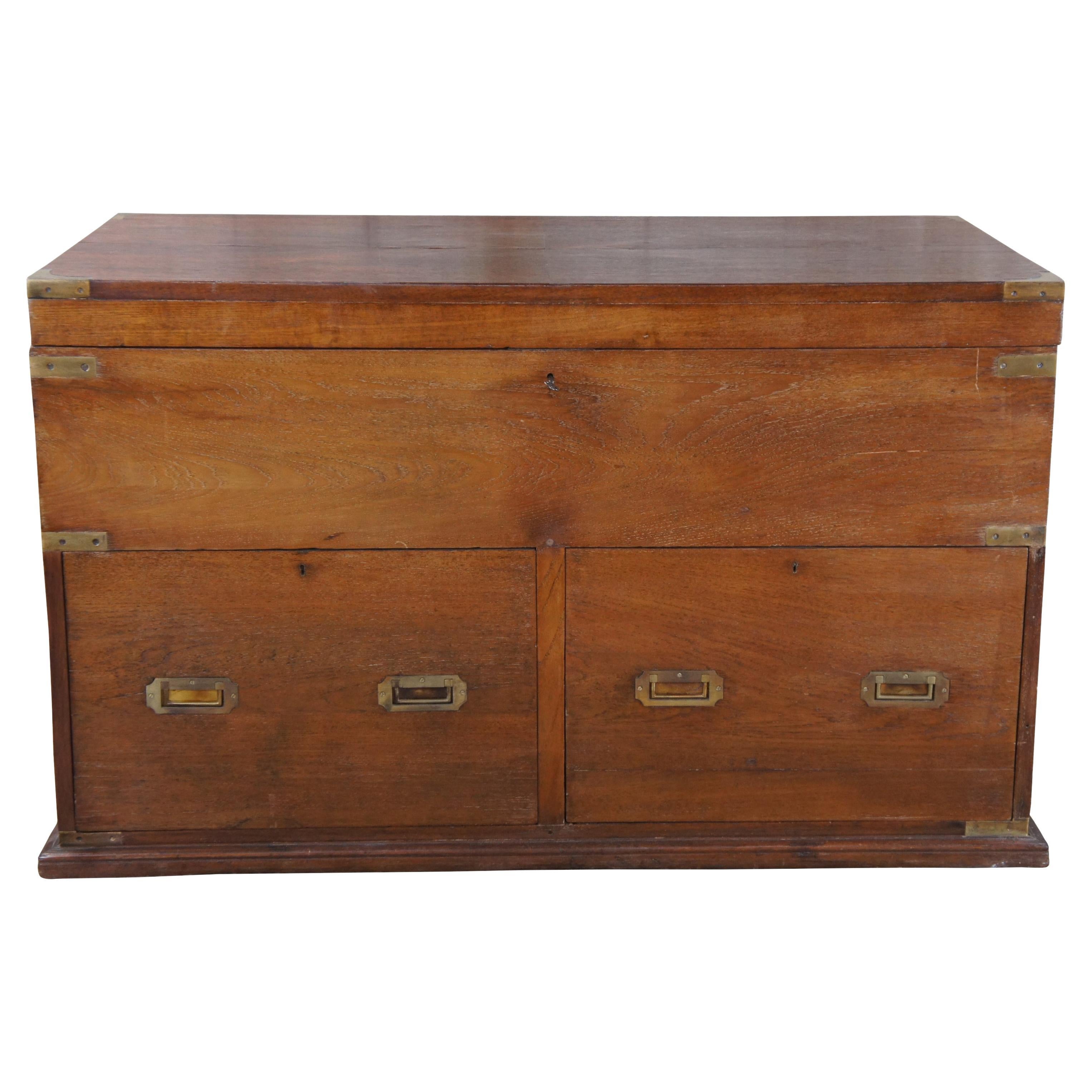 Antique English / British Colonial campaign trunk or chest, circa 1850s. Made of camphor featuring rectangular form with upper storage trunk and lower drawers. Accented with brass banding, hand dovetailing and handles. Very heavy.

Campaign