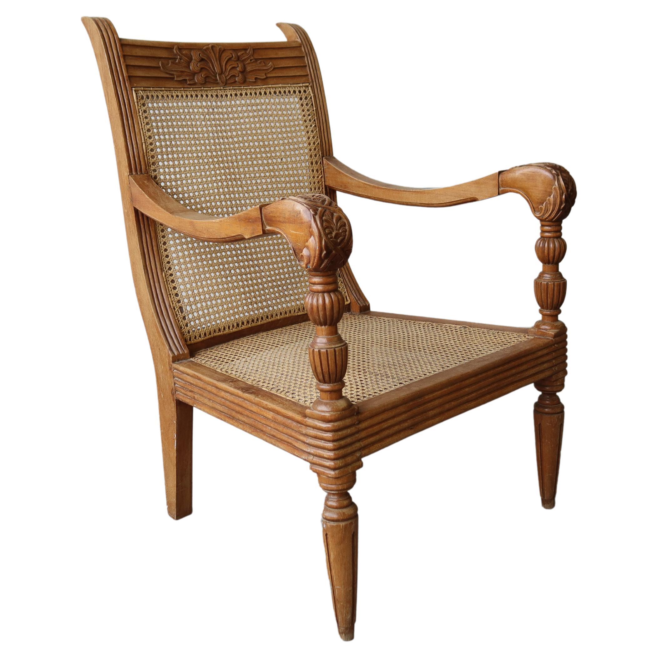 Antique British Colonial Cane and Carved Teak Lounge Chair