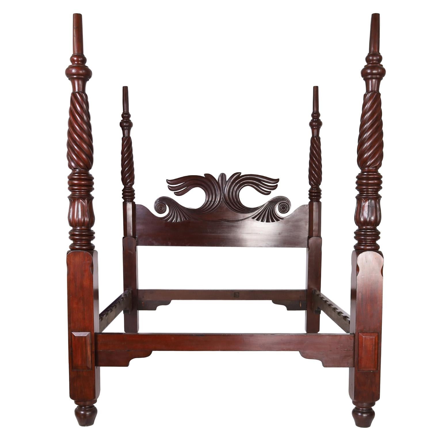 Rare and remarkable 19th century West Indies Queen size plantation poster bed handcrafted in rosewood having a carved headboard with an ocean wave motif and four turned, twisted and carved posts. Best of the genre.