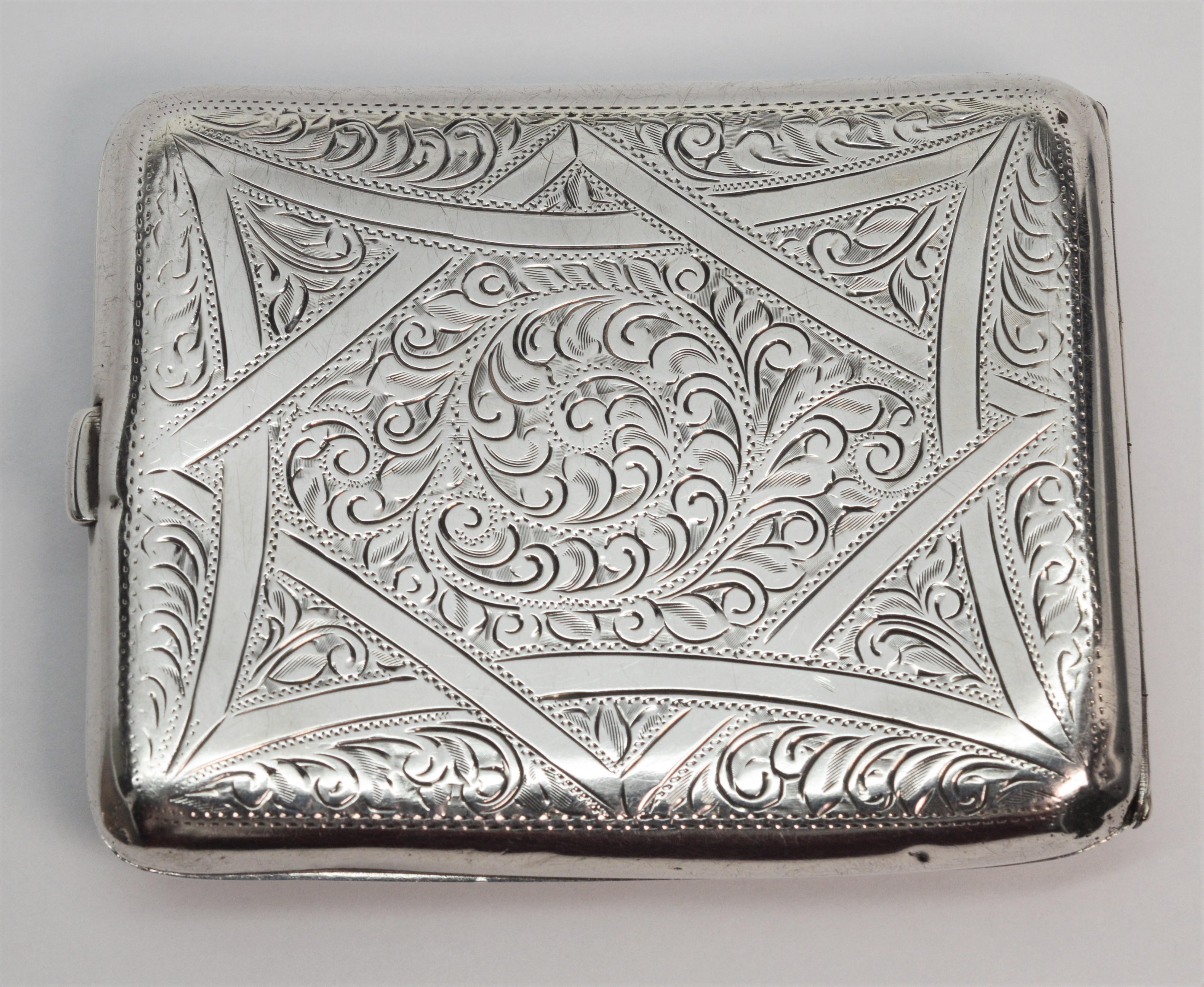 With British hallmarks, made in Birmingham England by Henry Williamson, circa 1924, admire the hand engraving on this beautiful antique sterling silver cigarette case. 
Measures 3-1/8 x 4 mm and fitted with clip closure and hinge which are both in