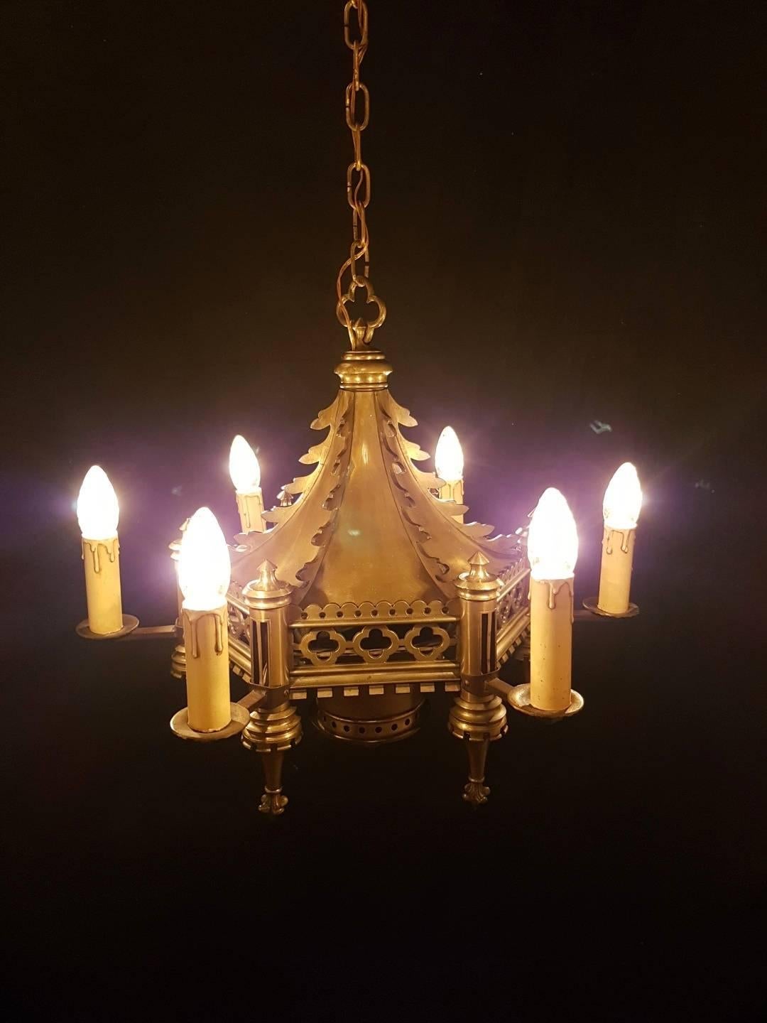 This six light gothic chandelier is made of bronze in 1890. There is an inscription in Latin which shows also the date of manufacturing.

This is just one of our large collection chandeliers. Besides the old and antique chandeliers we have