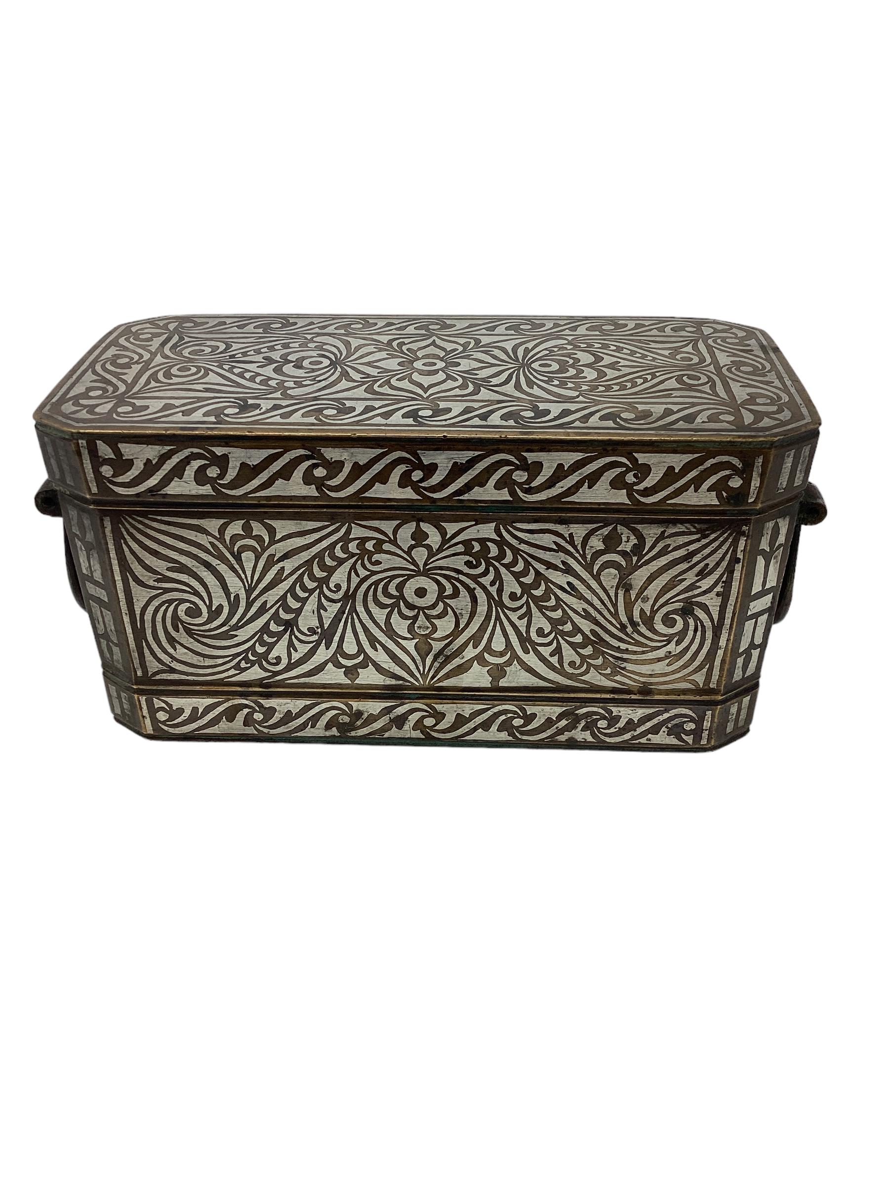 Southern Philippine (Mindanao) brass with silver inlay betel box. The top lifts to reveal 4 hinged compartments that held the betel leaf, areca nut, slacked lime and chewing condiments. The box is profusely inlaid in silver in the 