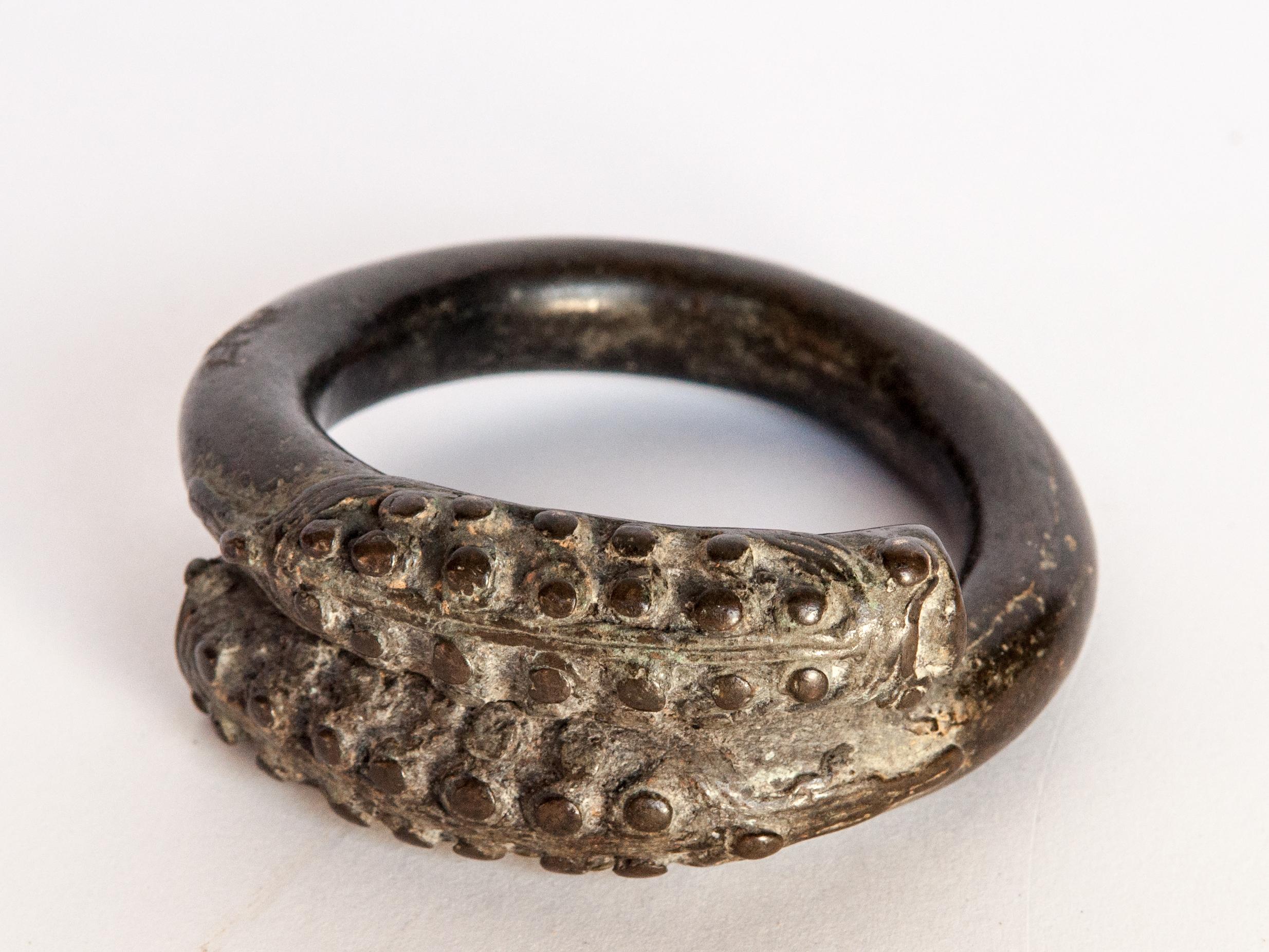 Antique bronze bracelet from Laos with a Naga or Serpent motif, 18th century.
Measurements: Outside diameter 3.75 inches; Inside diameter 2.5” inches; thickness is 1-3/8 inches thick. The weight is 372 grams (approx 13 oz)
It is in good condition.