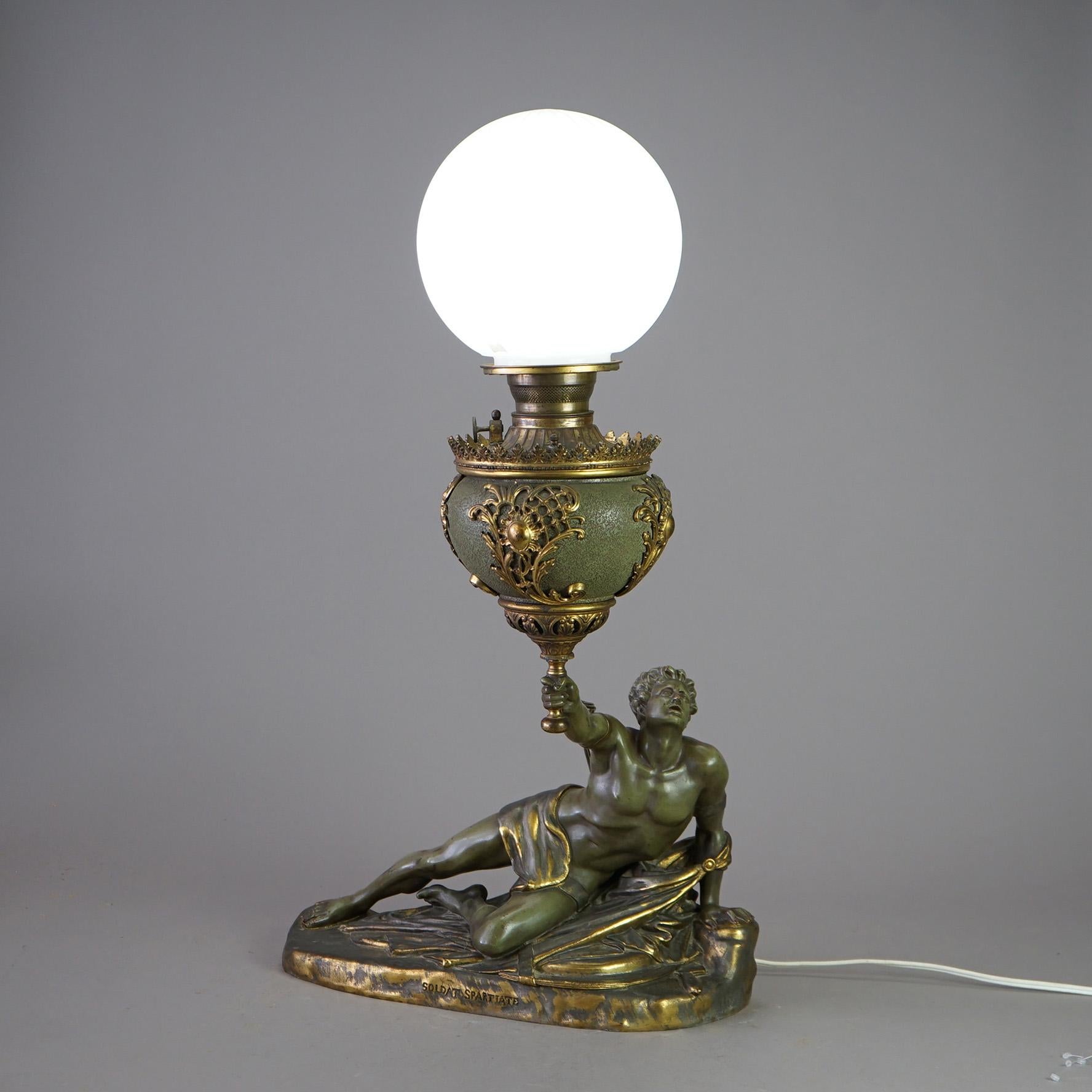 An antique figural 'Soldat Spartiate' table lamp after sculpture by Jean-Pierre Cortot (French, 1787-1843); bronze and brass base  depicts a Spartan soldier holding an oil lamp aloft; titled as photographed; electrified; c1810

Measures - 29