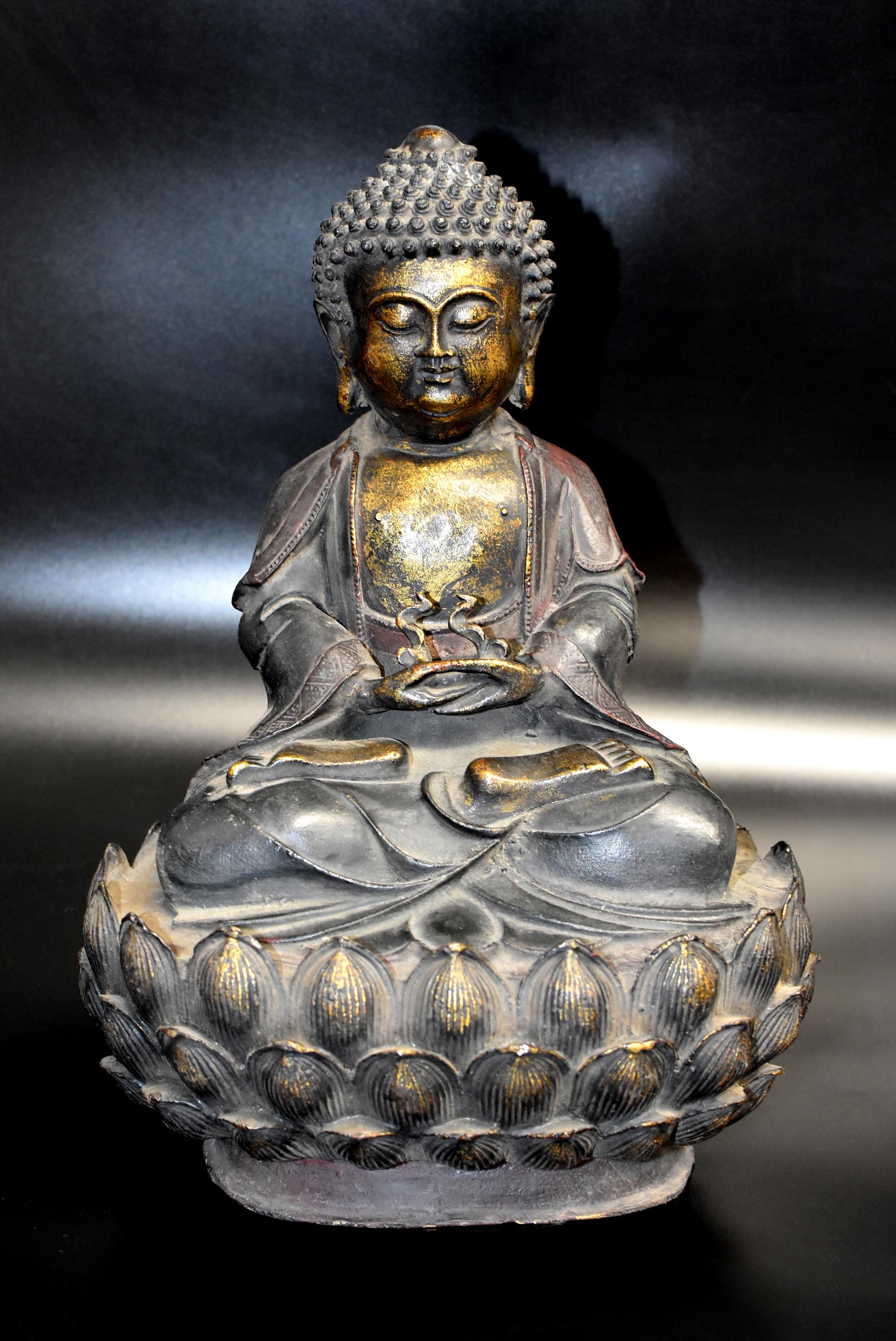A large, beautiful bronze Buddha. Flanked by pendulous earlobes, the full face with slender bow-shaped eyes and hooded eyelids casting a serene and meditative aura with downcast look, below evenly arched eyebrows tapering at the ends issuing from