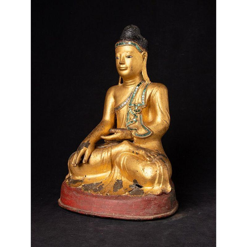 Material: bronze
35,7 cm high 
24 cm wide and 20,5 cm deep
Weight: 5.35 kgs
Gilded with 24 krt. gold
Mandalay style
Bhumisparsha mudra
Originating from Burma
Early 19th century
With inlayed eyes

