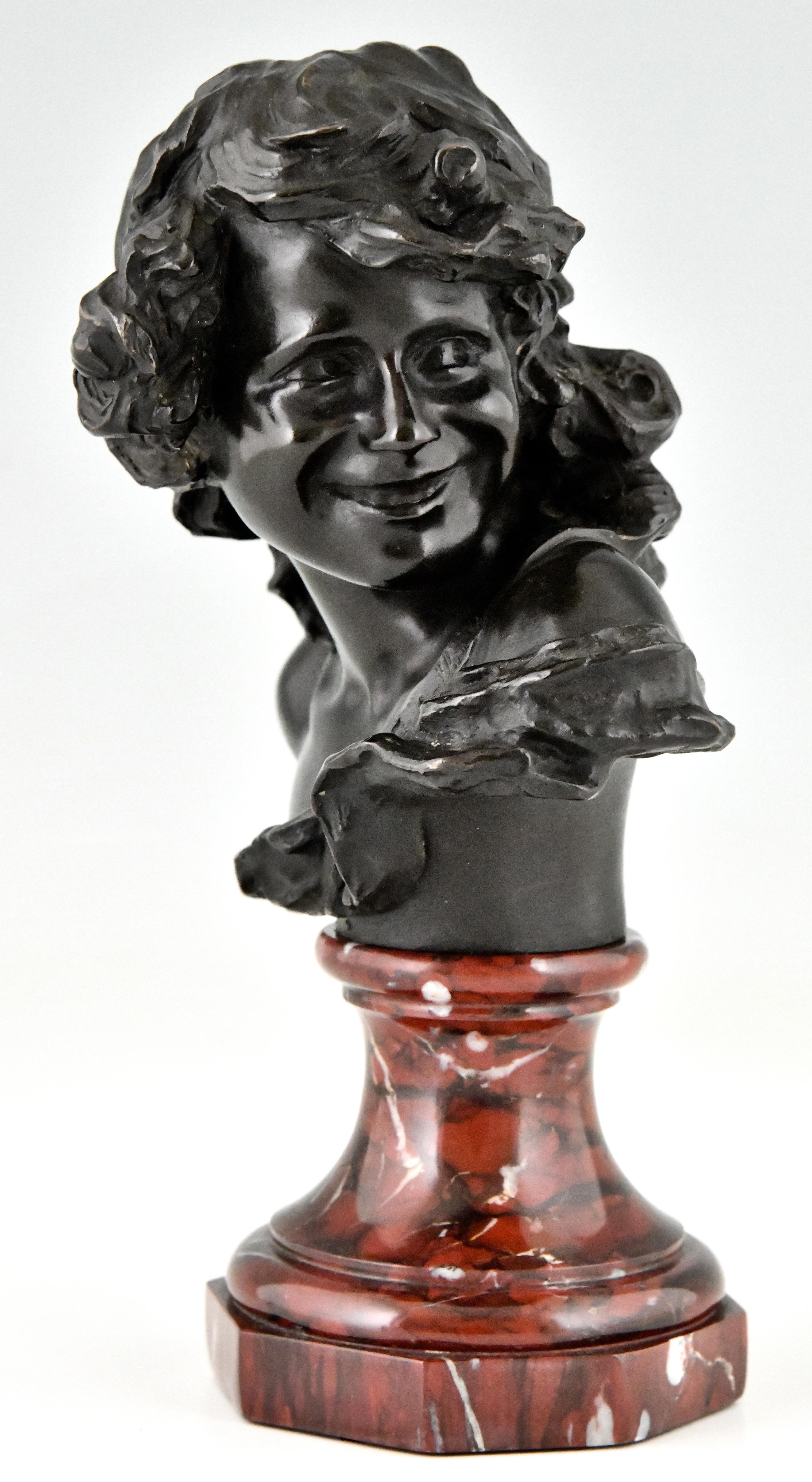 Antique bronze bust of a smiling child by Jean Antoine Injalbert. Foundry mark Siot Decauville Paris, Numbered. France 1900. 
Bronze, patinated. Belgian red marble base. 
Jean Antoine Injalbert, Beziers 1845-Paris 1933. 
There is a picture of