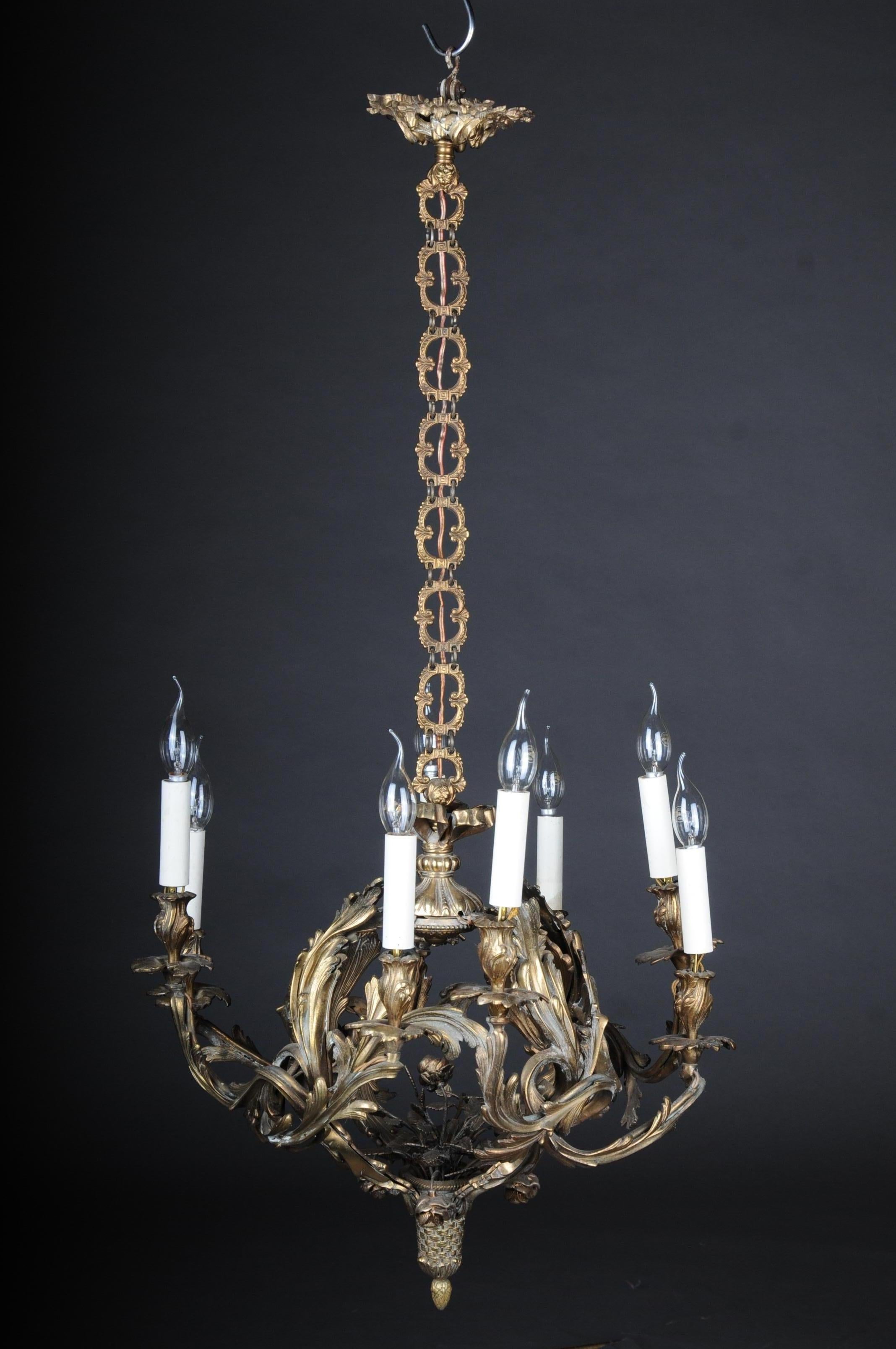 Antique bronze crown / chandelier Rococo, circa 1900

Solid, beautifully chased bronze body, gold-plated. Heavily decorated baluster shaft, starting with eight volute-like curved light arms. With electric candle shaft and sleeves. A very beautiful
