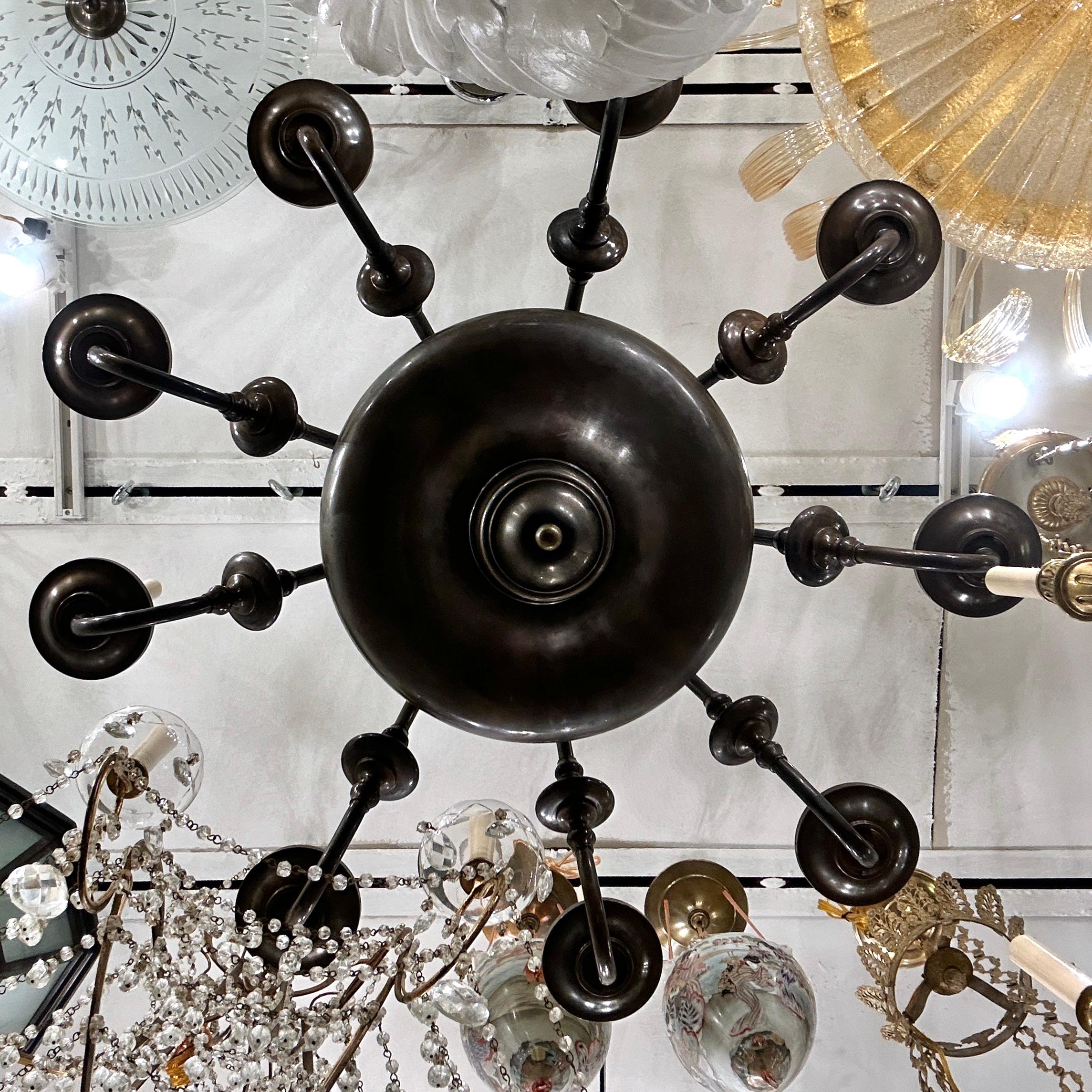 A circa 1920's antique patinated bronze Dutch chandelier with 8 lights.

Measurements:
Diameter: 38