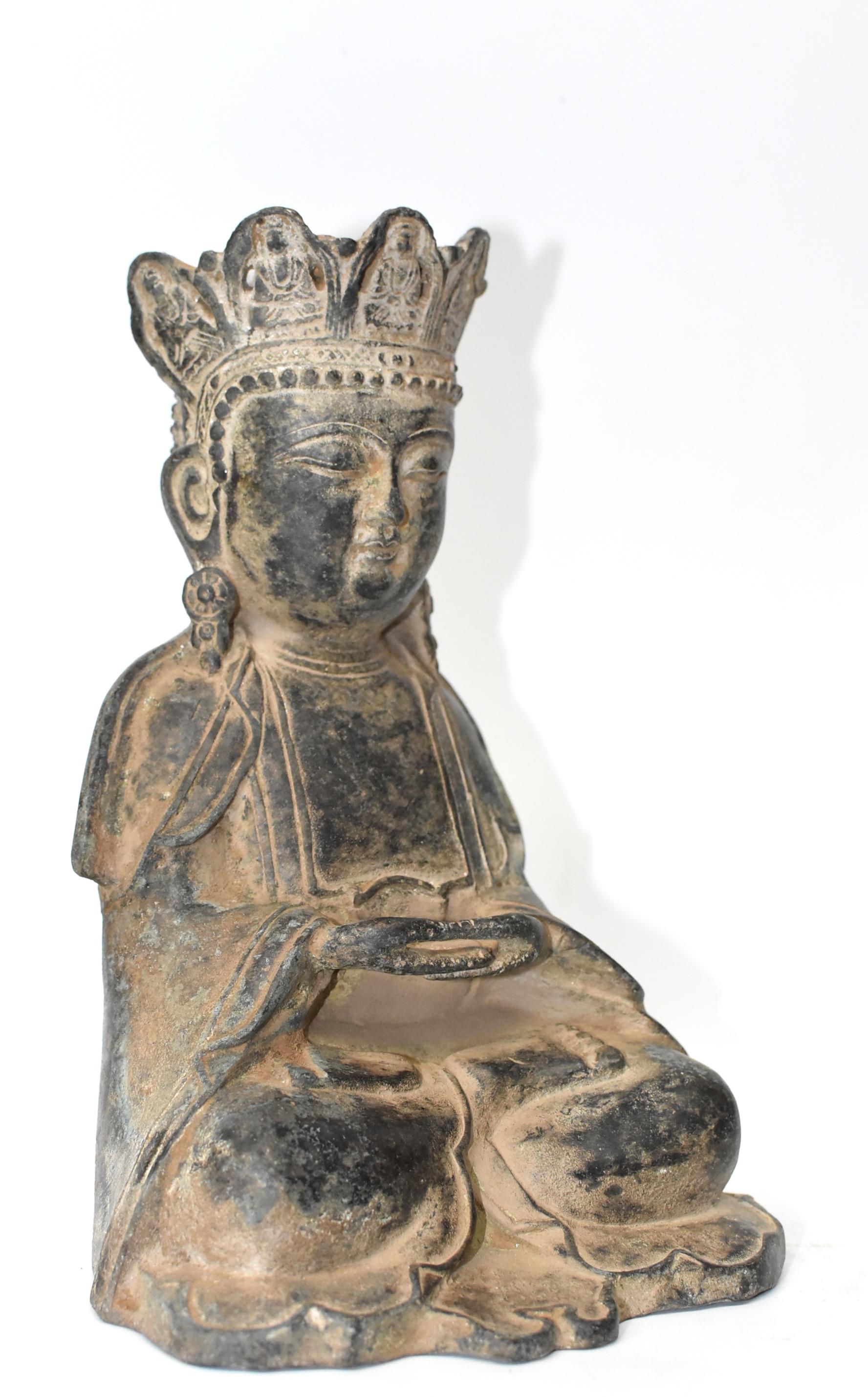 A beautiful antique bronze Earth Buddha. The Buddha has a traditional Tang full face and very peaceful expression. His hands are connected in a unity and peace mudra. Buddha wears a fluid robe, and a decorated crown. Made in the Qin dynasty in the