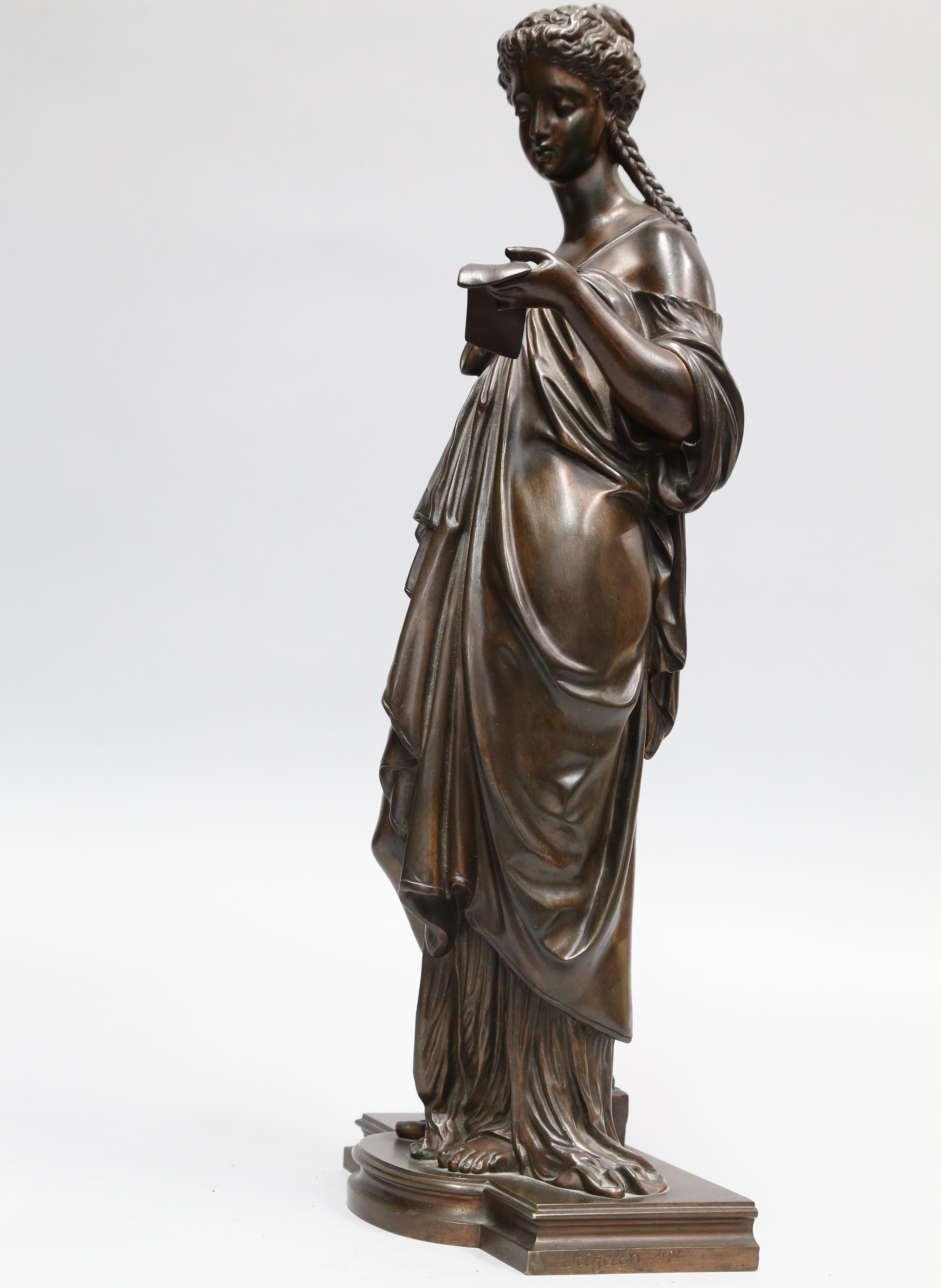Exquisite bronze sculpture by Eugene Aizelin (French 1821-1902) featuring a strikingly beautiful statue of a female figure standing and reading a letter; set on plinth base. Dimensions: 16.5