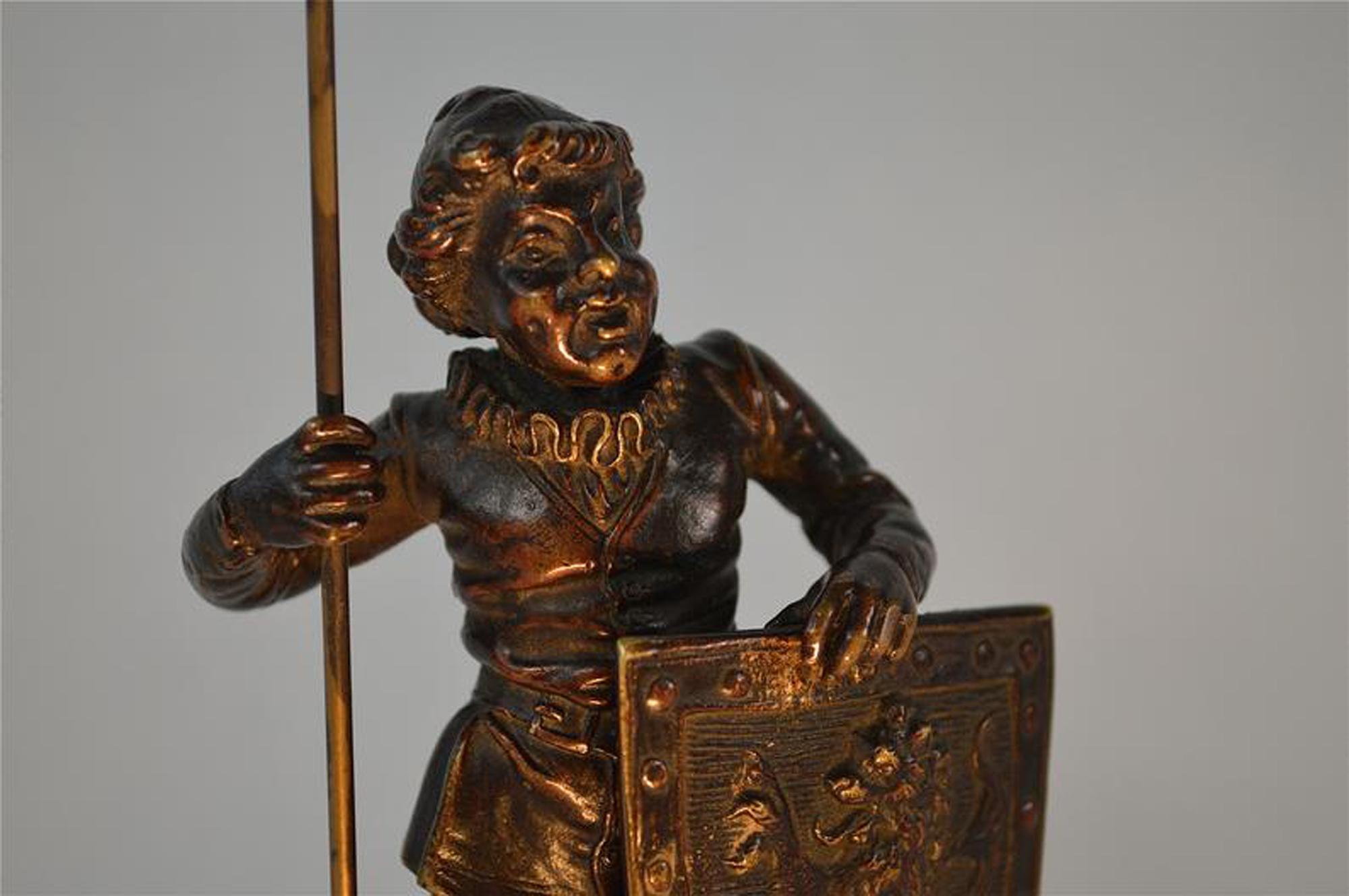 A charming antique figure of a medieval man holding a flag. Cast in solid bronze in Europe and dating from circa.1860. The figure is in good condition with a wonderful rich colour and patina. 19cms tall. 7 1/2 inches tall.