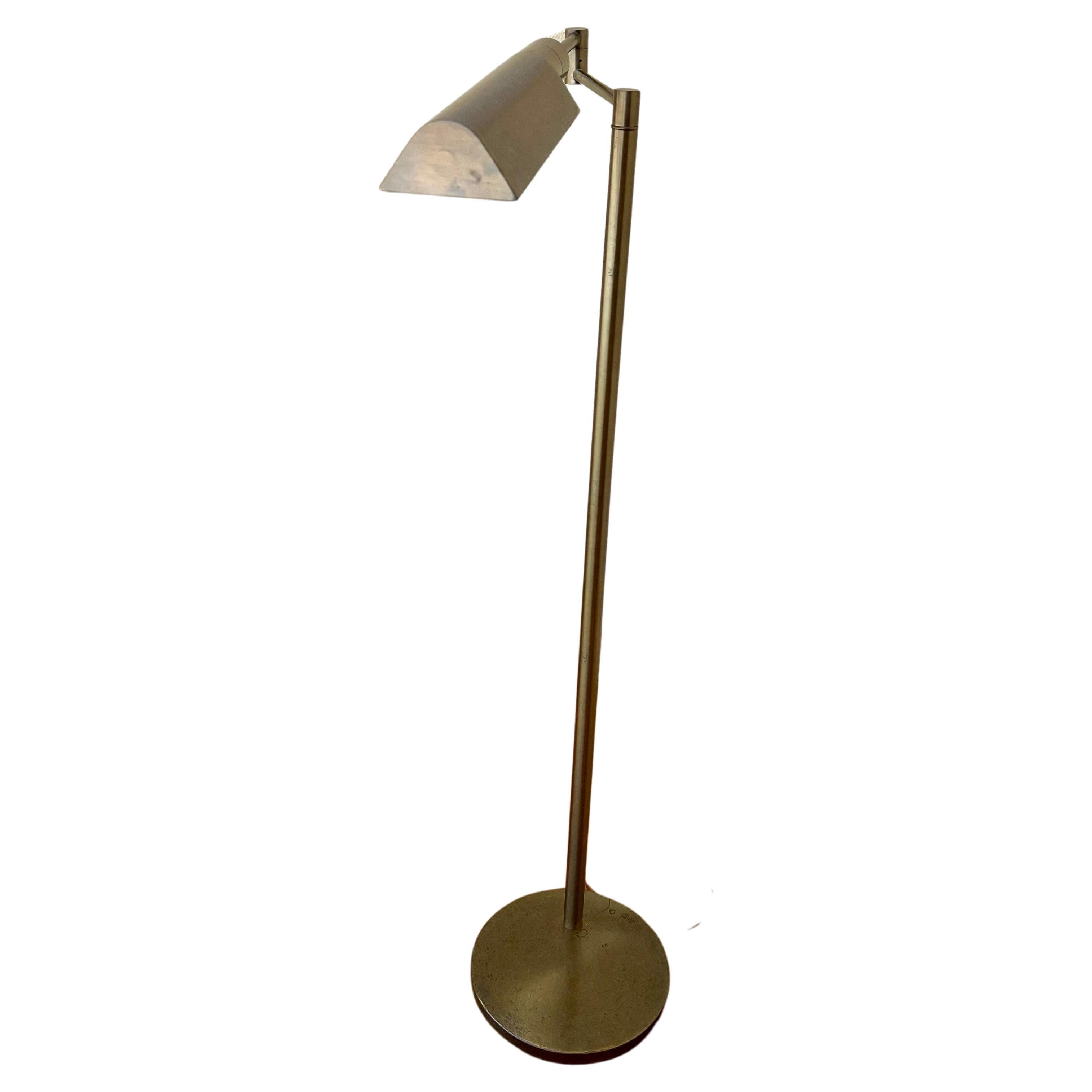 Elegant floor lamp in antique bronze finish by Casella Lighting, circa 1980s. The lamp is multi-directional and rotates from side to side and is in good working condition with a regular lightbulb and dimmer switch. The base is solid and heavy and