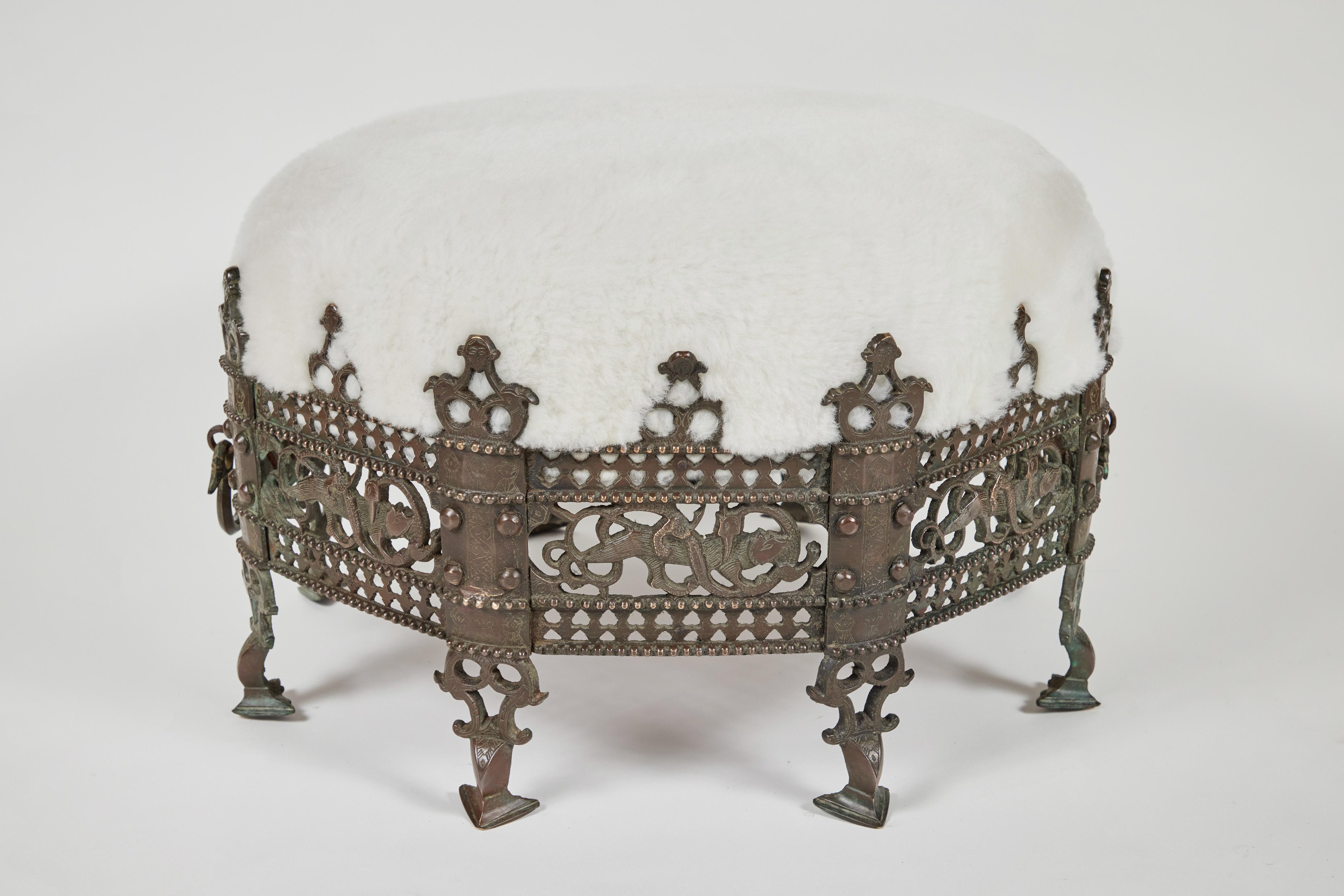 Did you see this one of a kind antique bronze footed intricately decorated 'Crown' framed stool with handles?
It is a very unique and stunning piece, has been newly upholstered in beautiful soft white shearling and is quite the special addition to