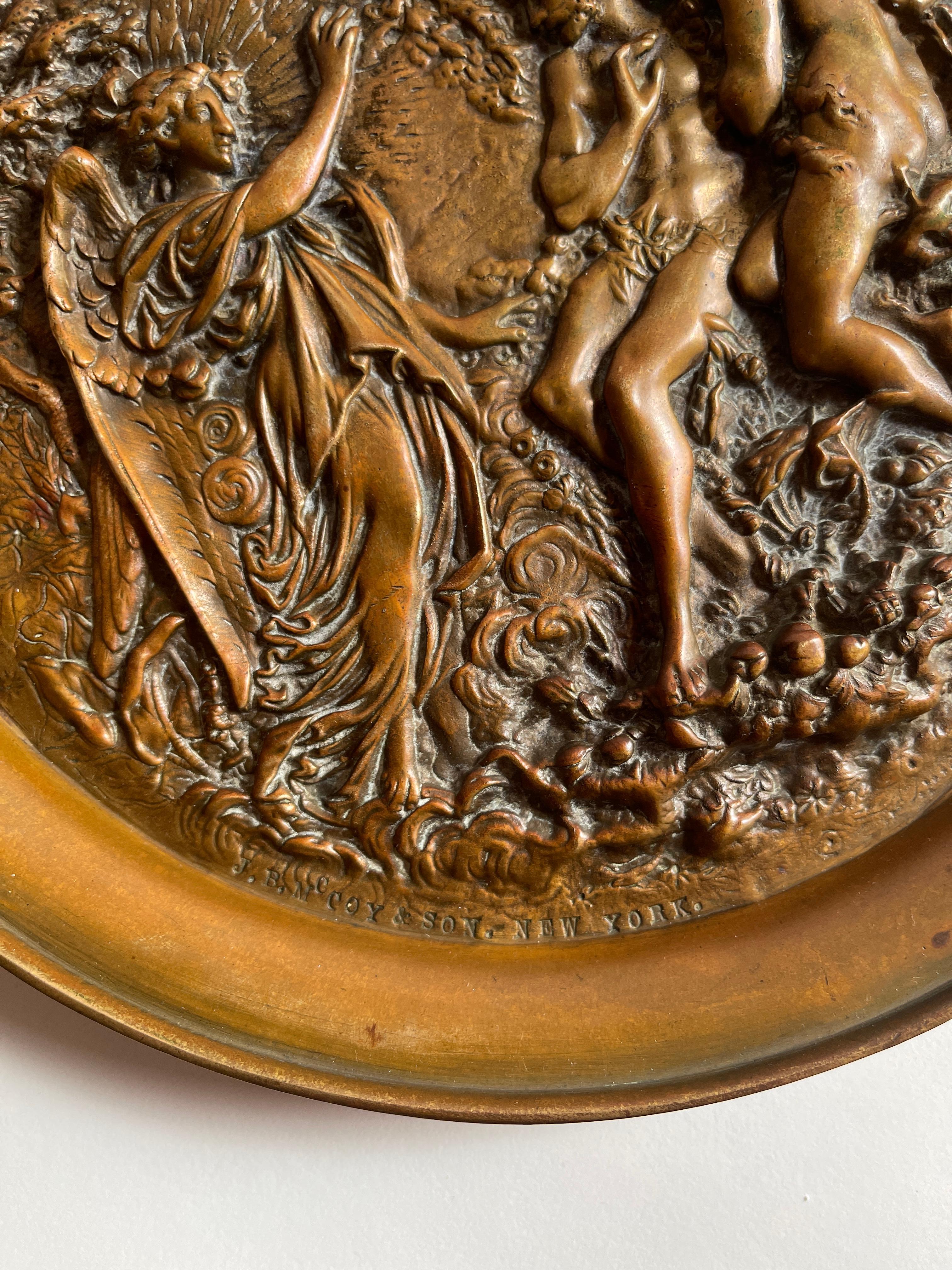 Antique cast bronze hanging plaque with Adam , Eve and the Angel in the Garden of Eden. Finely detailed lush foliage, palm trees, surround the garden. Stamped in lower left rim, J.B. McCoy & Son, New York.
Wire loop for hanging plaque on back side.
