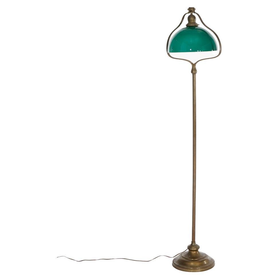 An antique floor lamp by Handel offers bronze construction in harp form with green cased glass shade, c1920

Measures- 57.5''H x 13.25''W x 10.5''D.

Catalogue Note: Ask about DISCOUNTED DELIVERY RATES available to most regions within 1,500 miles of