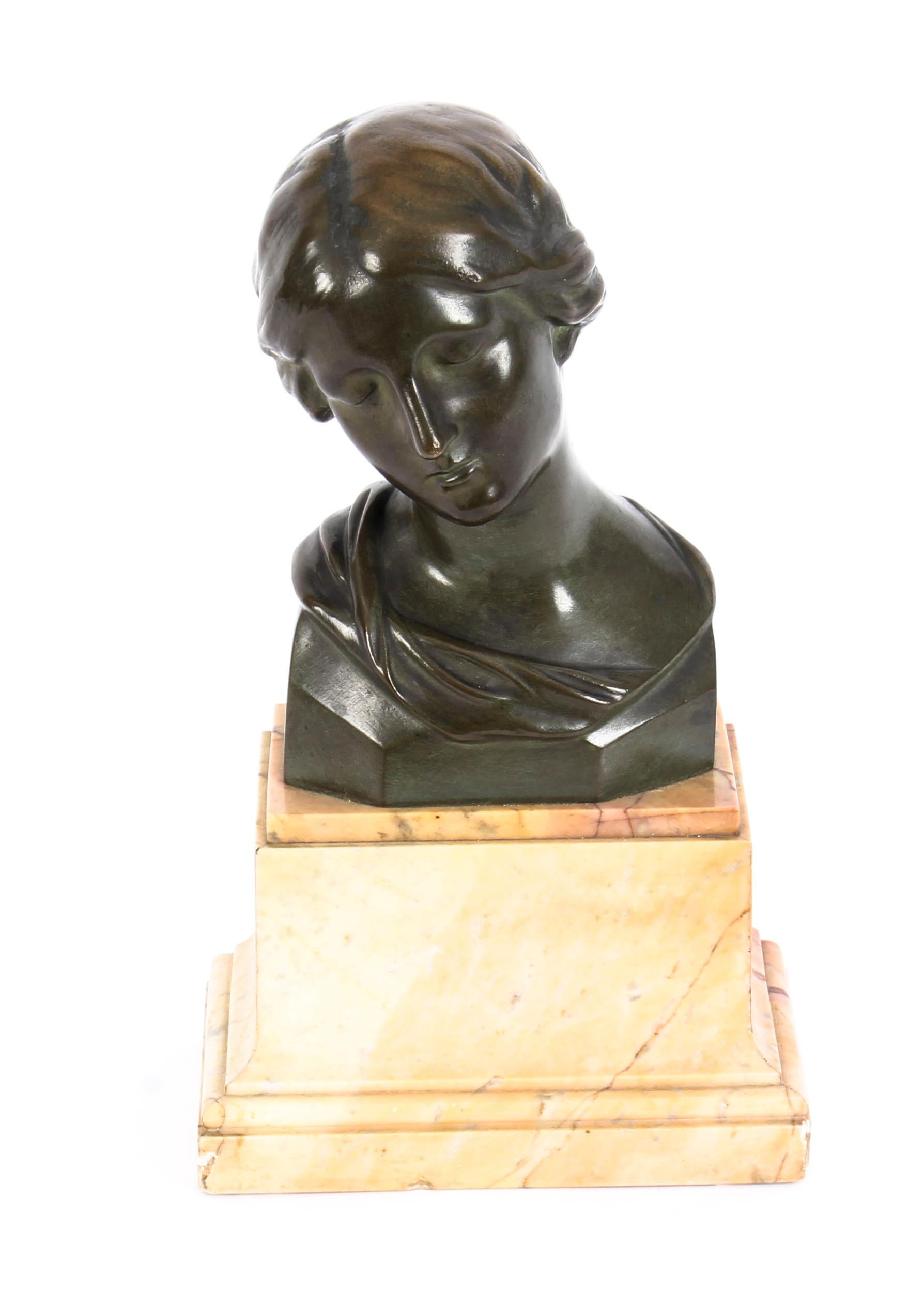 This remarkable dark brown patinated bronze bust is after a sketch of the head of lady by the world-famous Renaissance painter, Raphael, and features a beautiful classical young woman looking downward while being caught in an angelic mood. Her