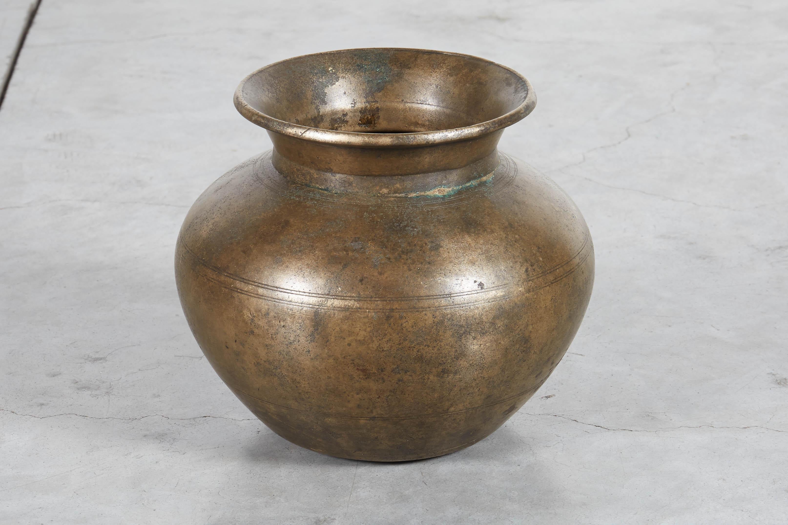 A beautifully patinated antique bronze holy water vessel from Nepal with attractive and subtle detail. A truly spiritual and handsome piece.
M2032a.