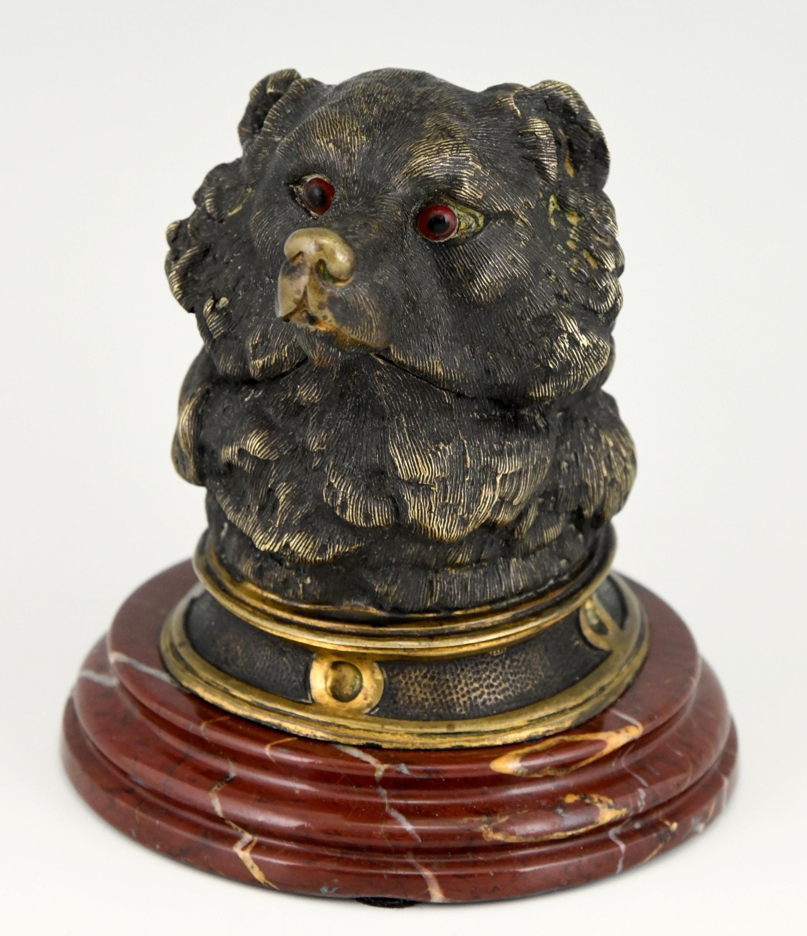 Antique bronze inkwell in the shape of a bear's head with glass eyes.
The sculpture is mounted on a red marble base and has a glass container. 
France, ca. 1880.