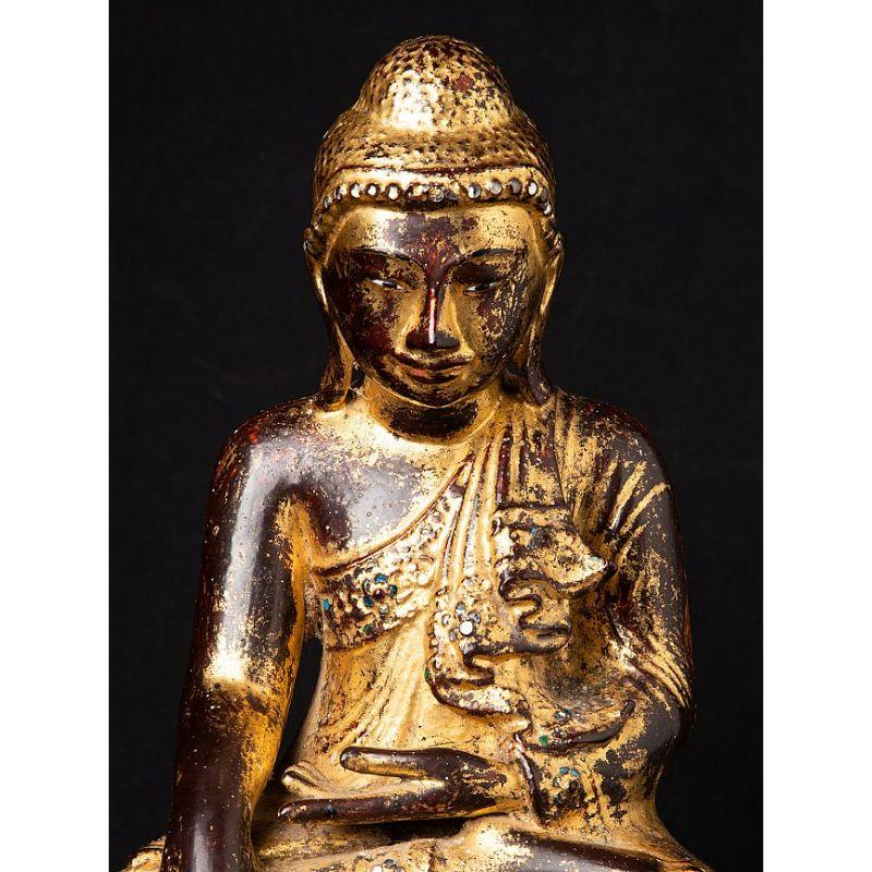 Material: bronze
Measures: 36,3 cm high 
29,2 cm wide and 19,9 cm deep
Weight: 8.55 kgs
Gilded with 24 krt. gold
Mandalay style
Bhumisparsha mudra
Originating from Burma
19th century
With inlayed eyes.

