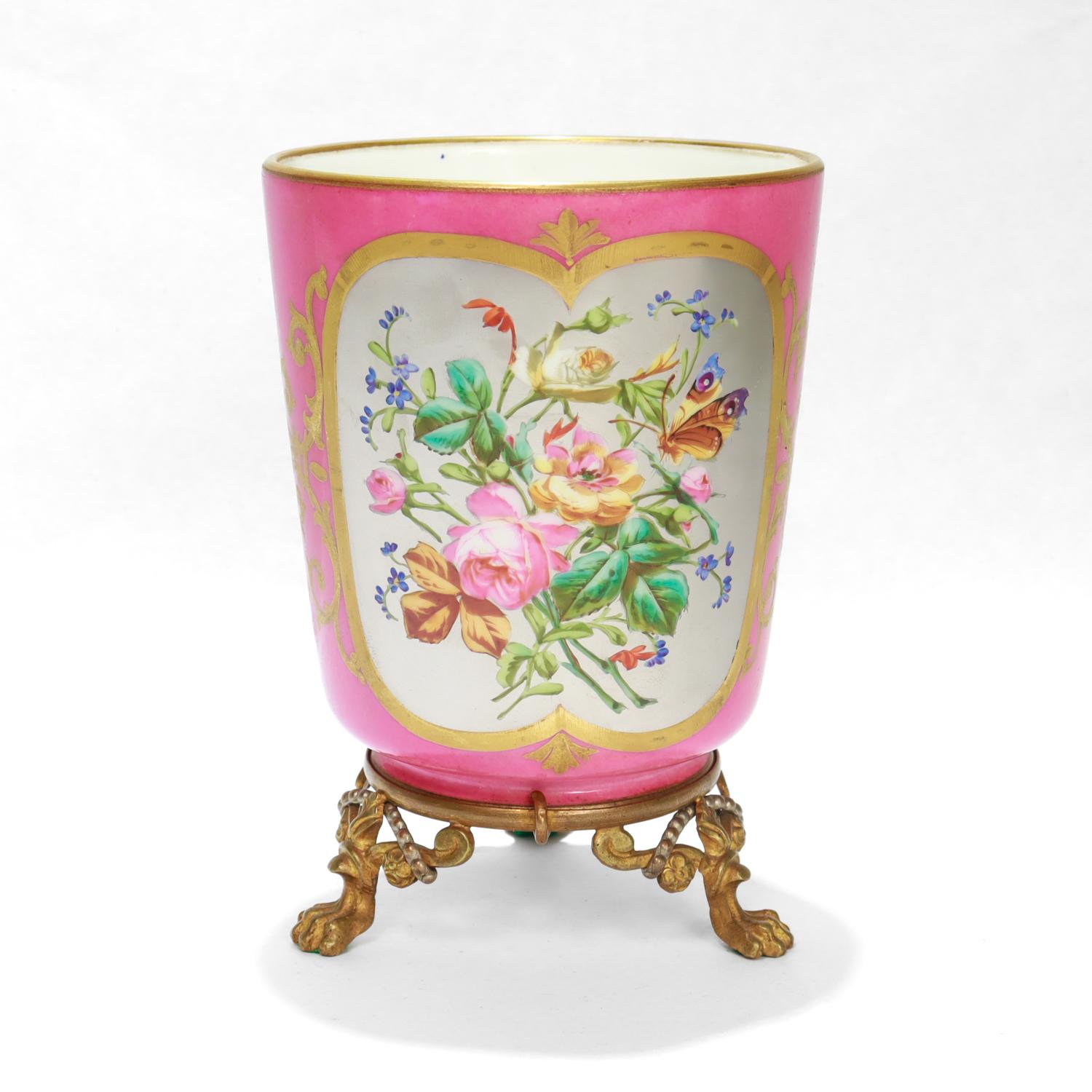 A fine antique French bronze mounted porcelain vase.

The body in a deep pink with gilding to the rim and foot rim, a Rococo gilt patterns framing the central cartouche, and a central cartouche with a painted floral scene with a butterfly on a