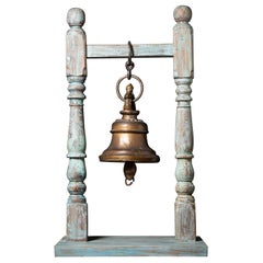 Antique bronze Nepalese temple bell on a wooden stand from Nepal