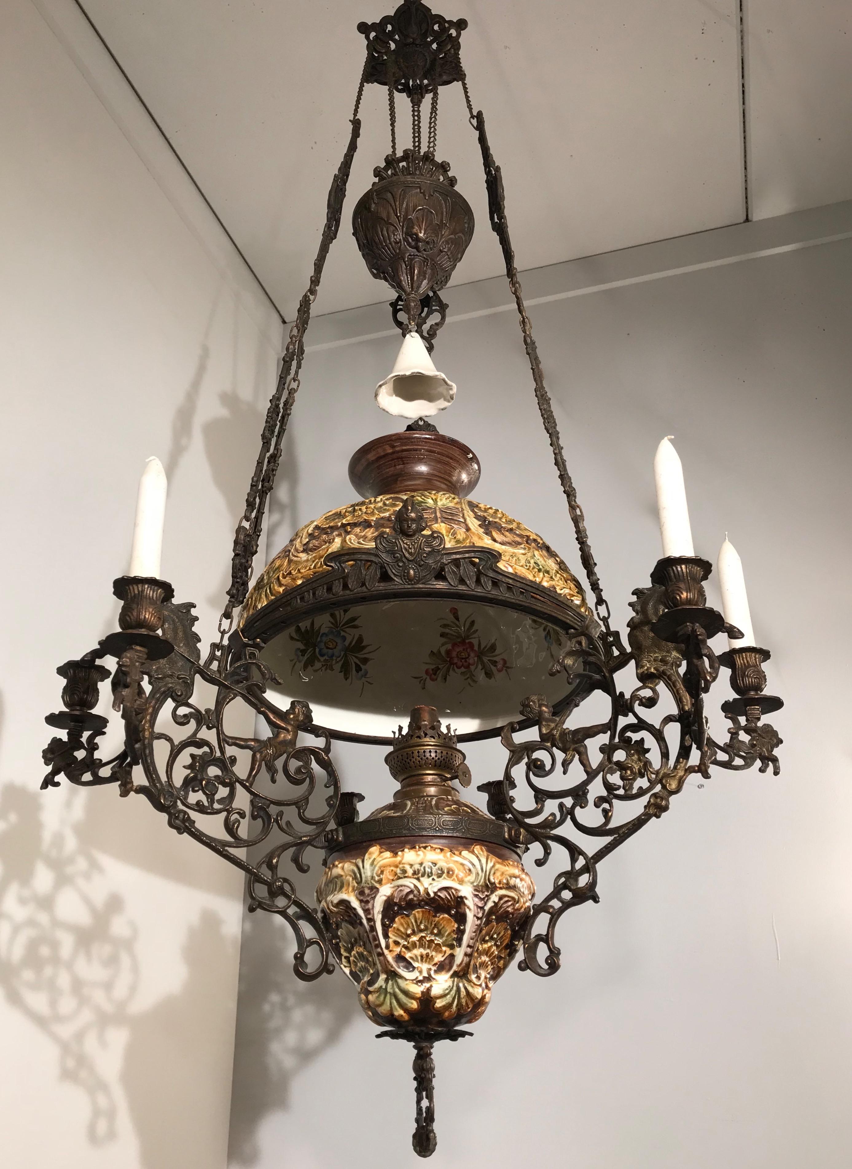 Rare figural oil lamp and chandelier into one.

This large and impressive oil lamp dates from the Arts & Crafts era. It is made of very expensive materials and techniques. This is one of the reasons why this rare antique is such a striking piece.