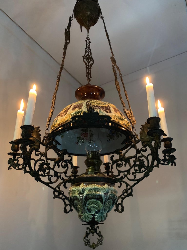Rare figural oil lamp and chandelier into one.

This large and impressive oil lamp dates from the Arts & Crafts era. It is made of expensive materials and techniques and this is one of the reasons why this rare antique is such a striking piece. This