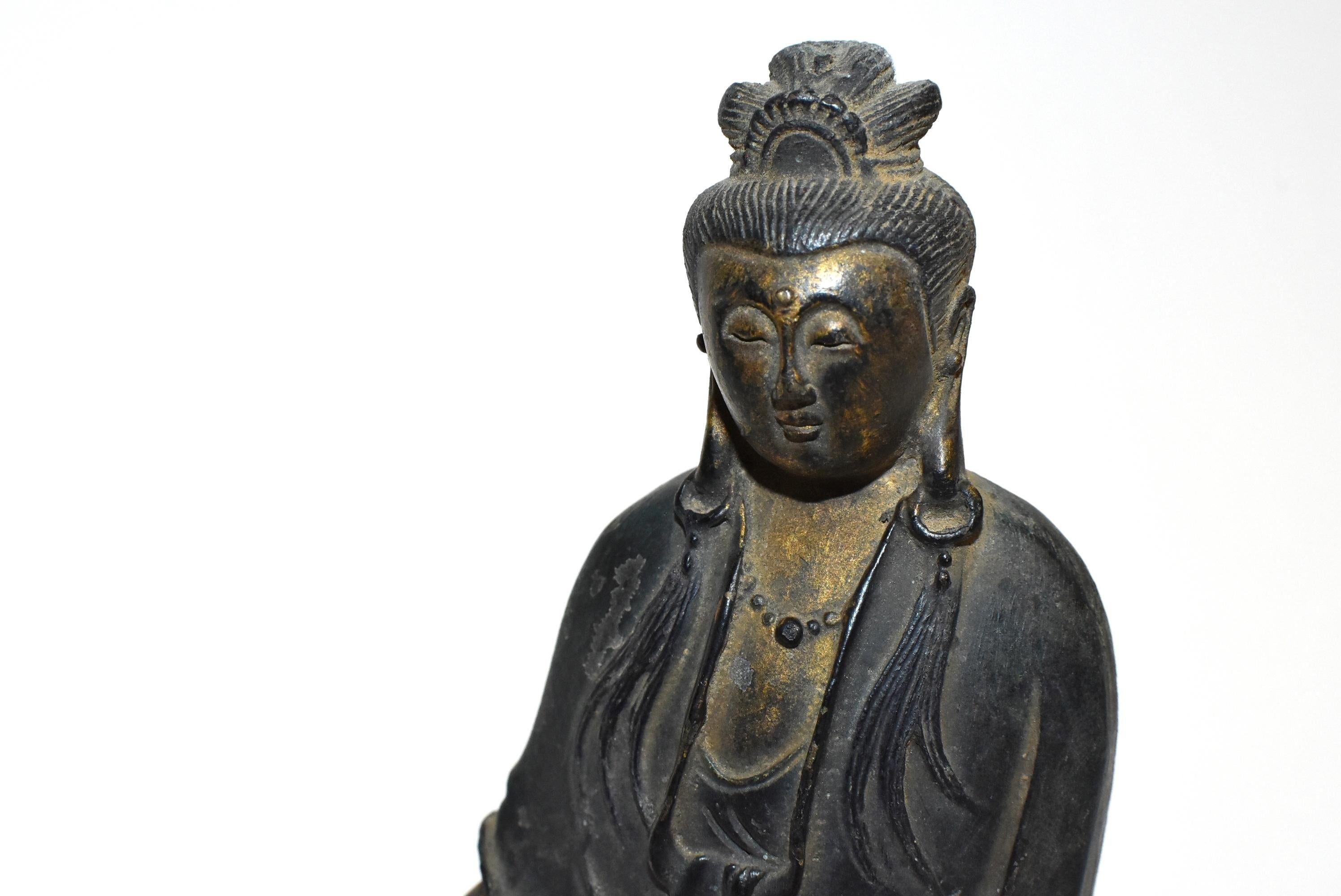 A very refined 19th century polychrome bronze guan yin statue. The graceful figure wears an elegantly draped robe and beaded necklace. The sensuous full faces with eyes casting a serene and meditative aura, below evenly arched eyebrows, the forehead