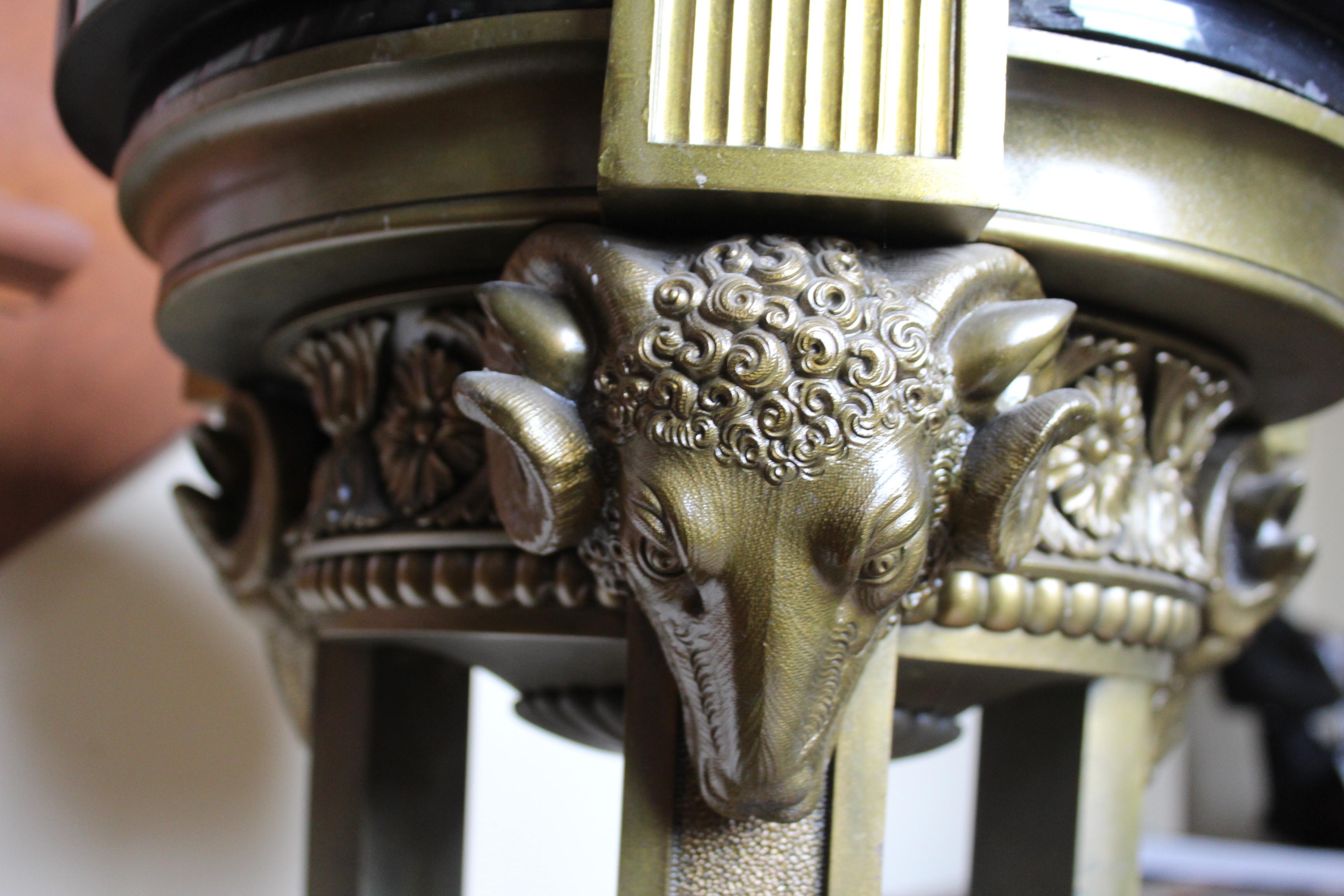 A very fine detailed Casting of Rams Heads and further details around the top part . All together on three Leg base with splayed feet .Has a nice golden patina finish . The marble top 16