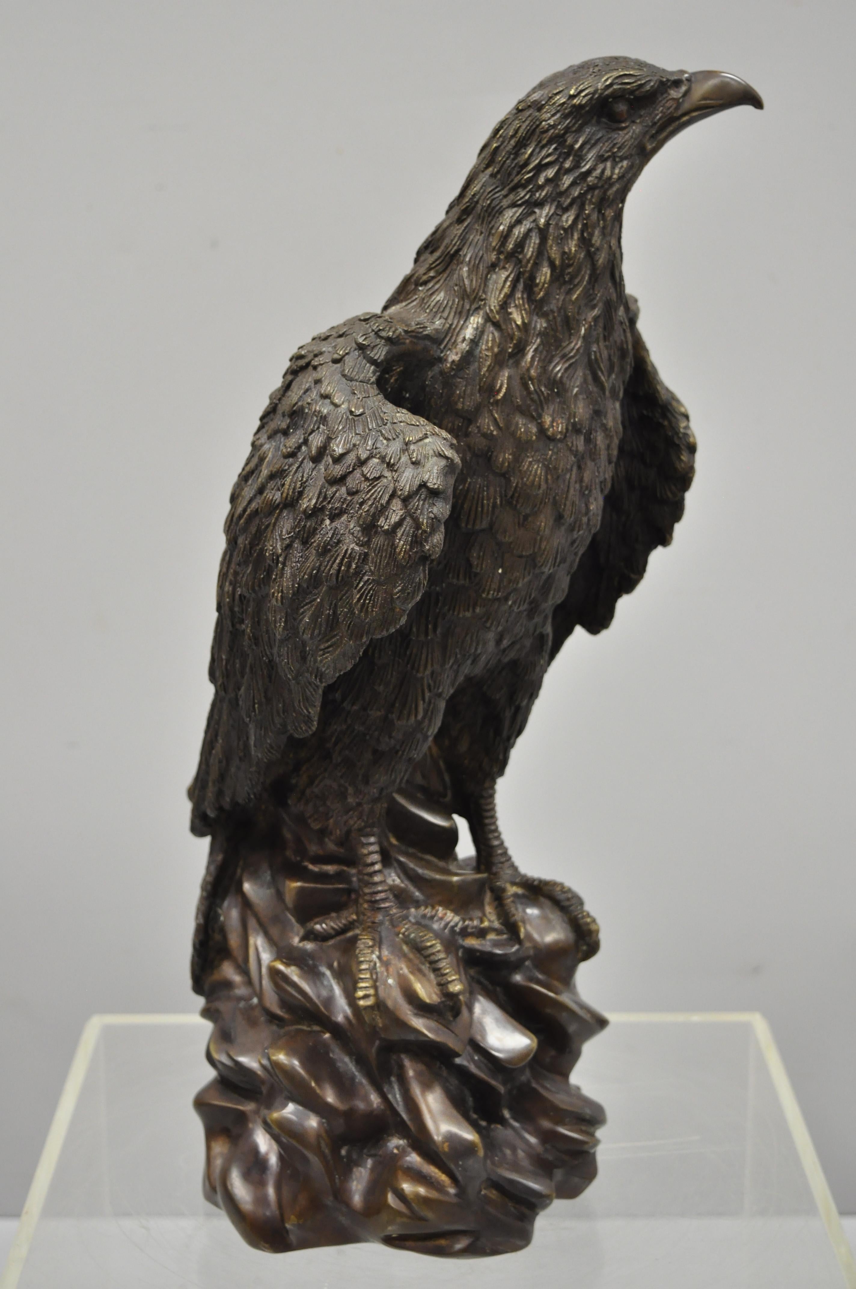 Antique bronze perched eagle above rocks, 22