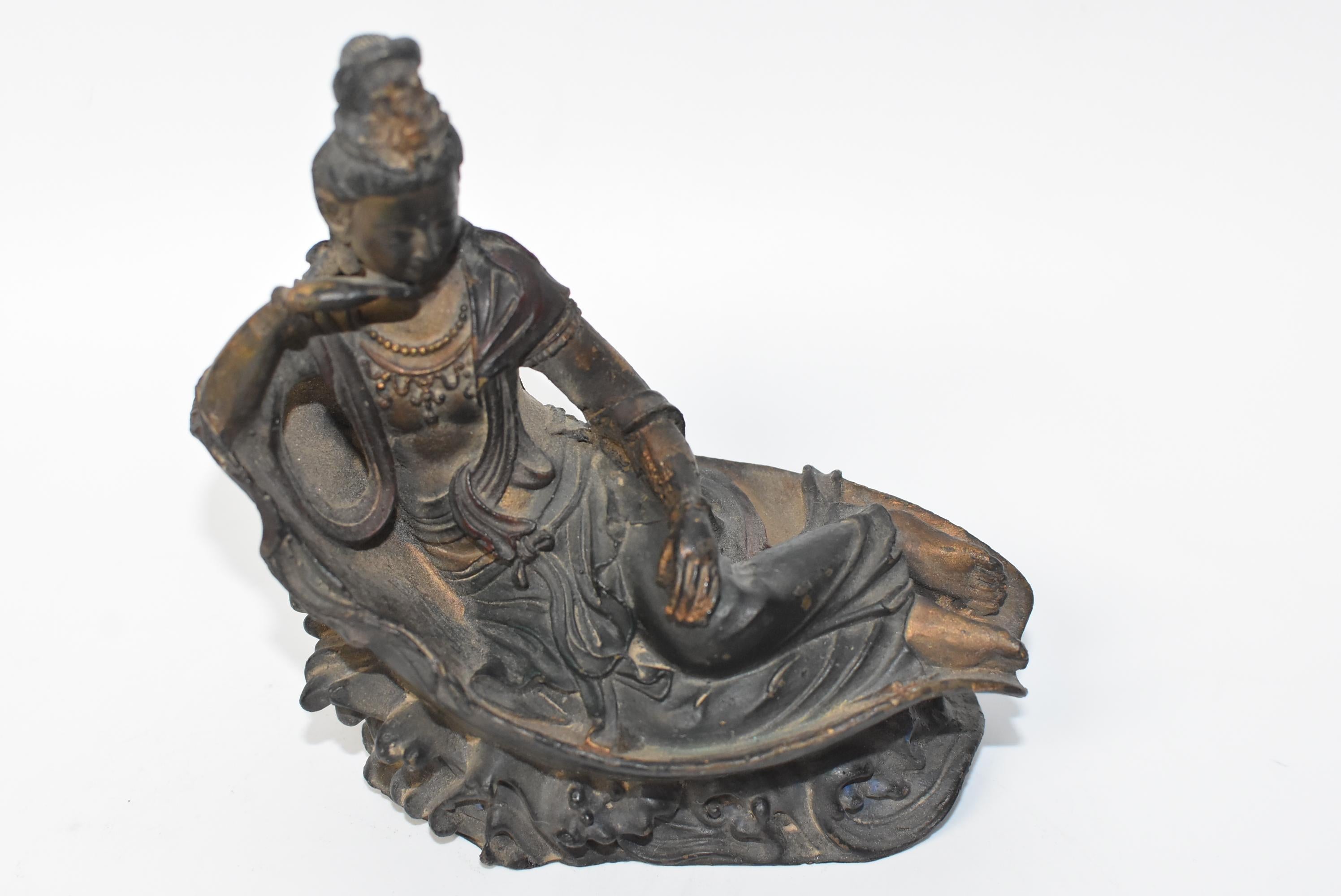 A small, fine example of the beautiful antique reclining Kwan Yin, one of the 4-piece collection we recently acquired. Kwan Yin is reclining on a lotus petal, perched on water waves. Her robe is fluid and soft. She wears a necklace and wears her