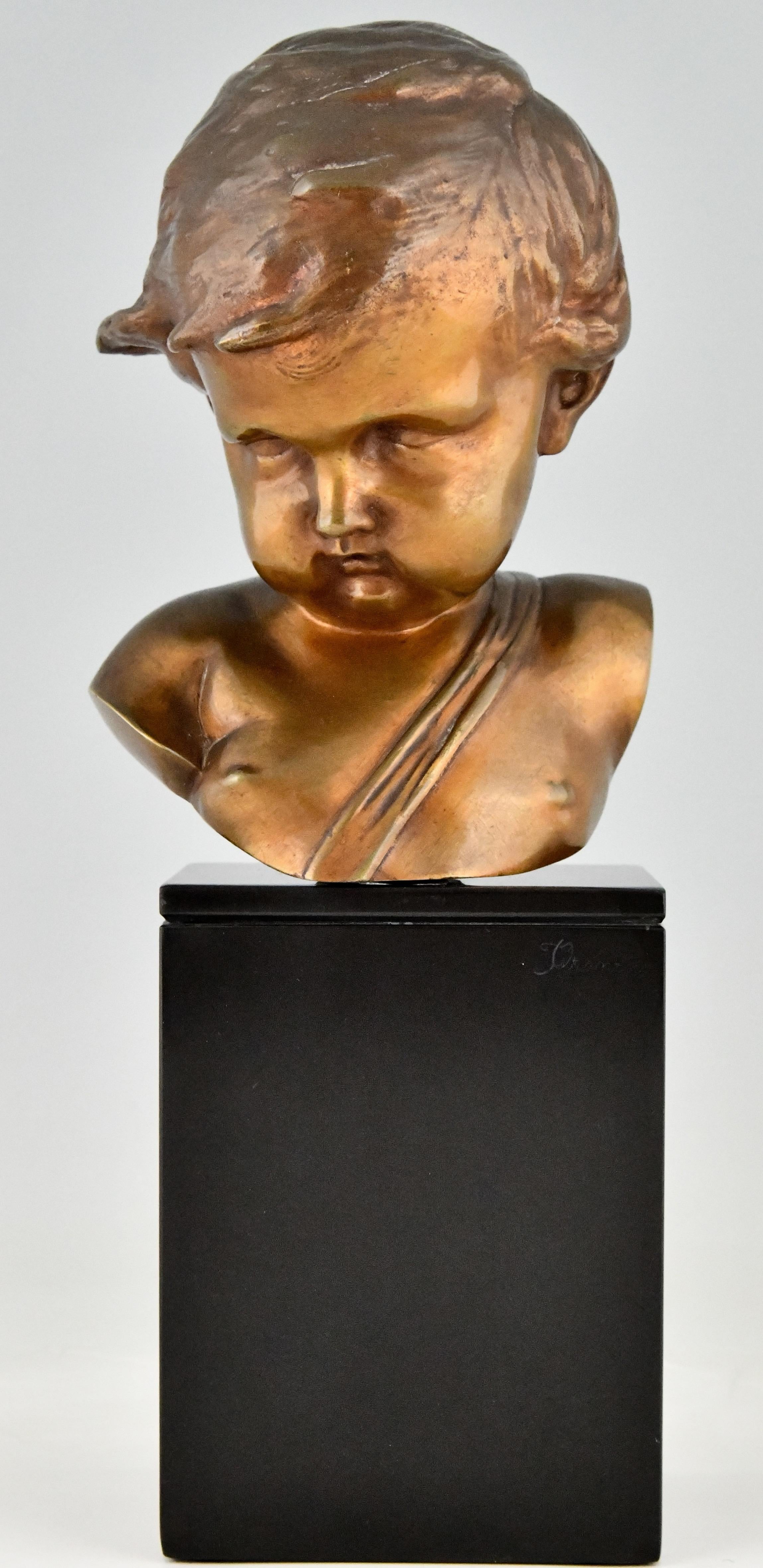 Antique bronze sculpture bust of a cupid in the style of François Duquesnoy (17 th. century) 
Patinated bronze on a Belgian Black marble base. 
France ca. 1900/1920.