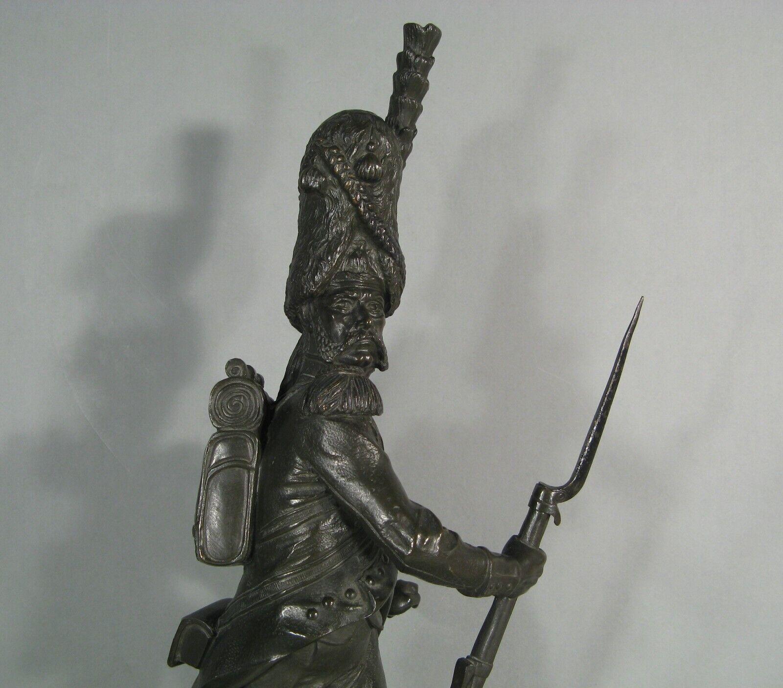 This remarkable antique bronze sculpture by renowned French-Italian sculptor Luca Madrassi portrays a grenadier of the Napoleonic Imperial Guard in exceptional detail. The statue, which includes a removable bayonet, is mounted on a marble base and