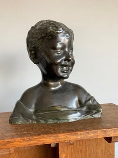 Sculpture ancienne en bronze représentant un garçon riant Desiderio da Settignano