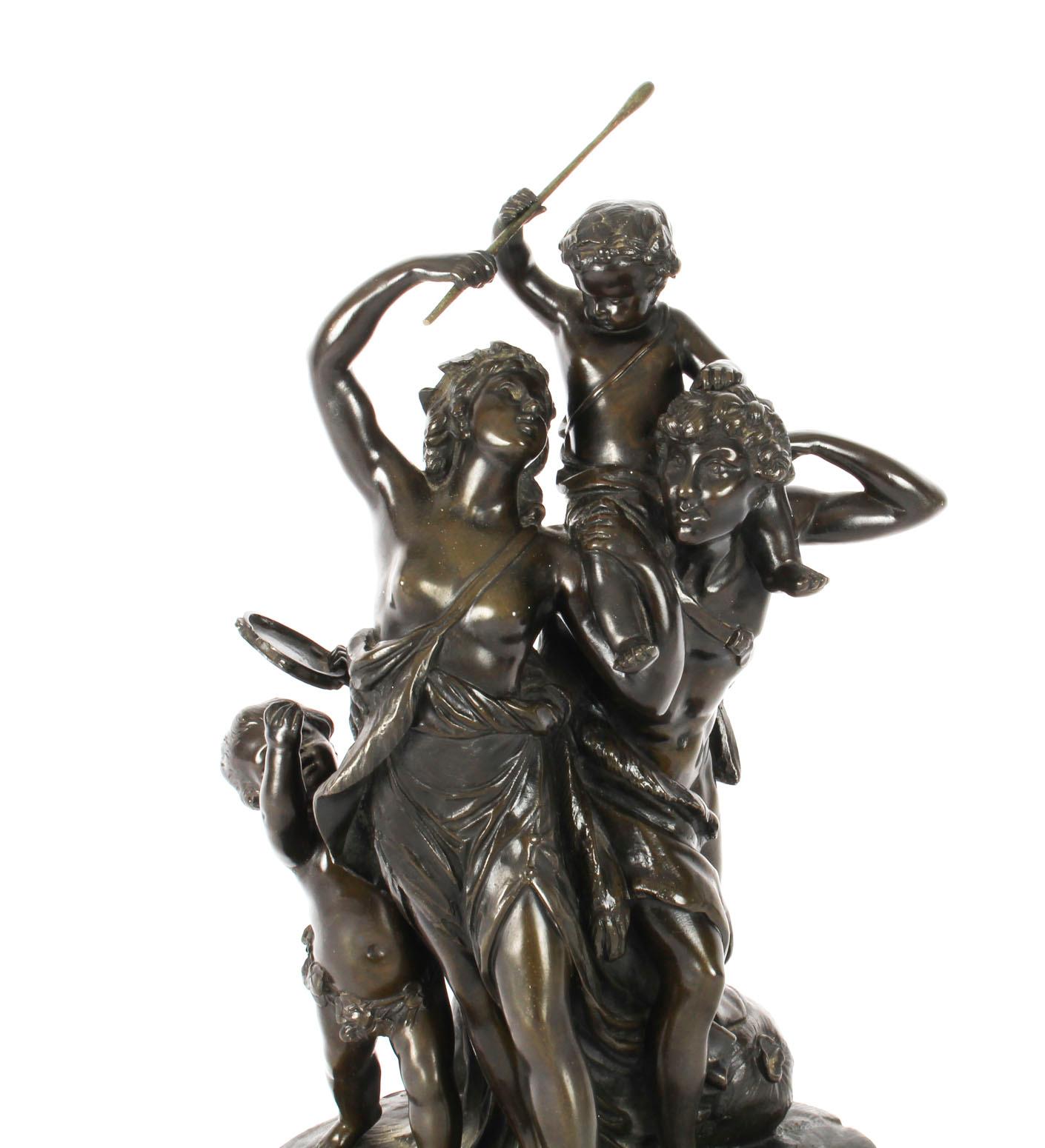 A finely cast striking patinated bronze sculpture of The Triumph of Bacchus, signed Clodion to the base, circa 1840 in date.
 
The sculptural figural group is in the form of Bacchus, a semi-naked maiden with a pair of cherubs one holding a