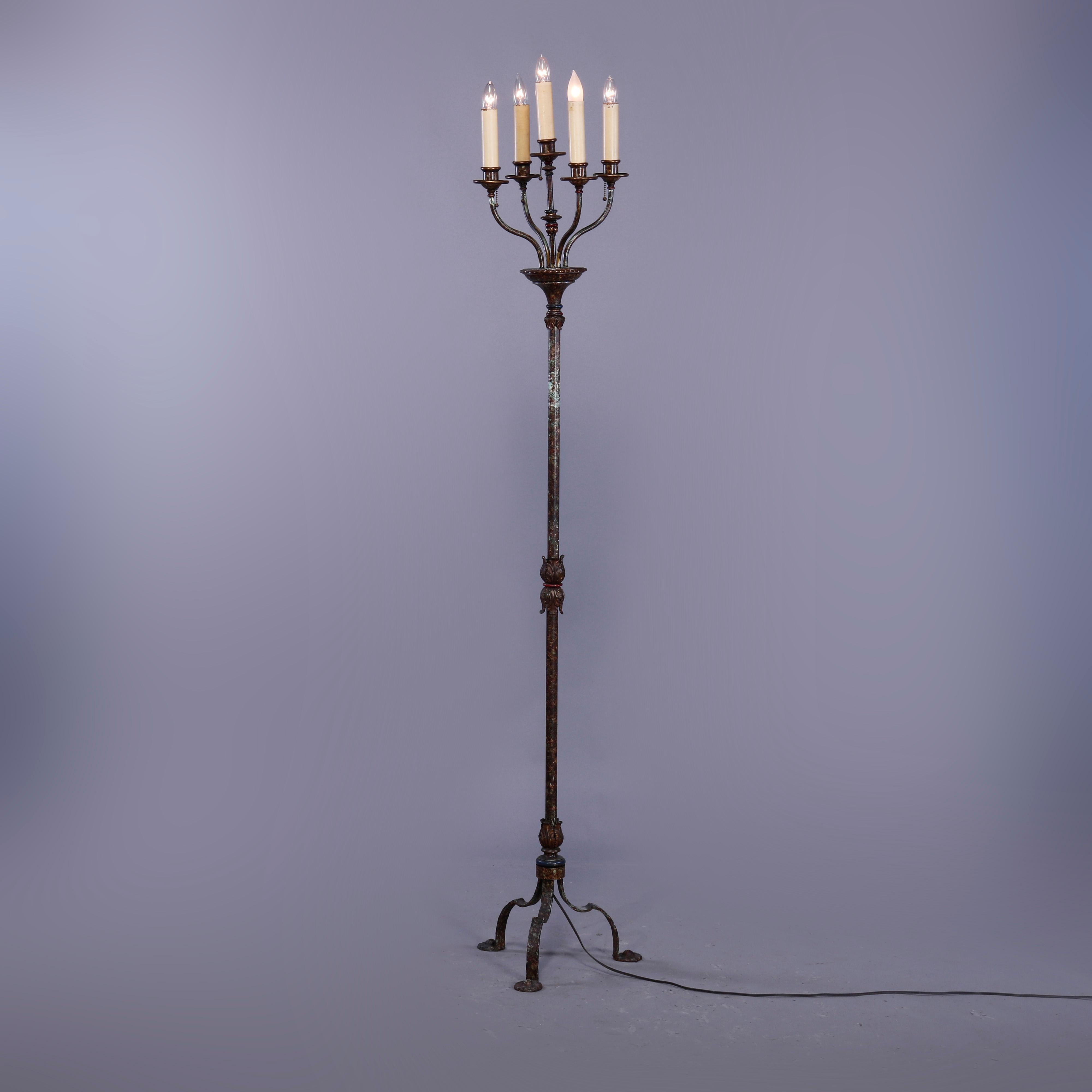 An antique floor lamp offers bronze and wrought iron construction with five light candelabra surmounting column with central acanthus band and raised on cabriole legs with foliate elements, c1920

Measures - 78'' H x 12.5'' W x 10.5'' D.