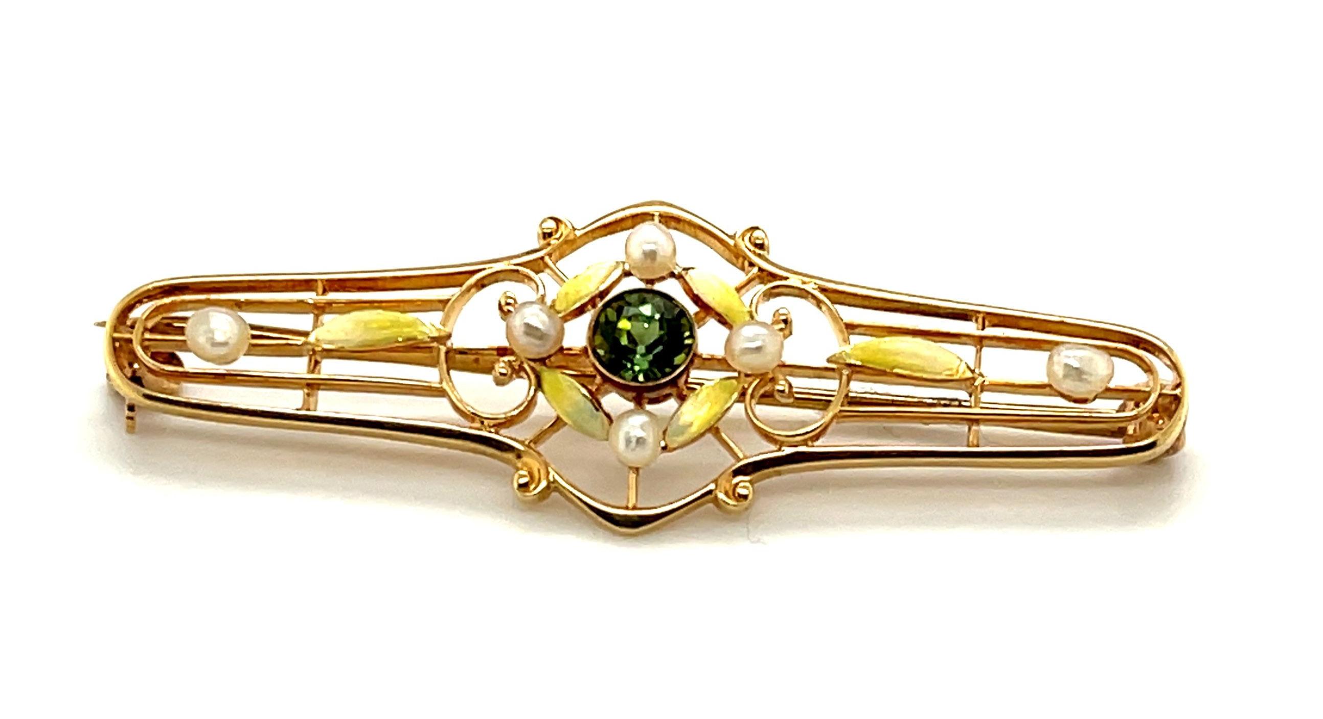 This beautiful 14k yellow gold Art Nouveau inspired pin features a very rare demantoid garnet, the rarest of all garnets. Displaying its characteristic green hue and brilliant fire, the 4.4mm demantoid garnet is framed by six 2mm white pearls and
