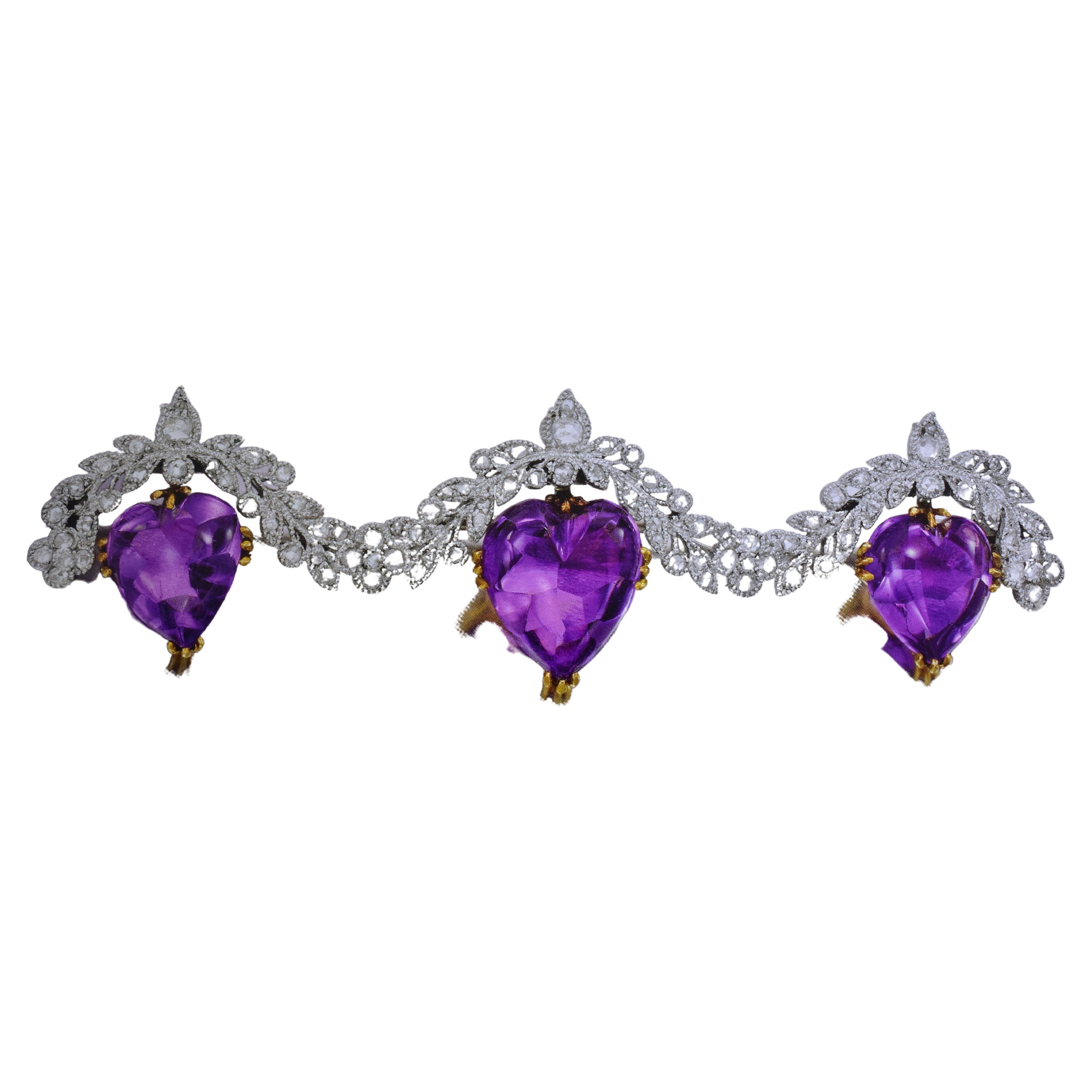 Antique heart shaped, buff-topped natural amethysts are suspended from a platinum and rose cut diamond garland.  The natural 3 amethysts are prong set in 18k yellow gold.  The platinum and diamond garland is well done exhibiting fine early 20th