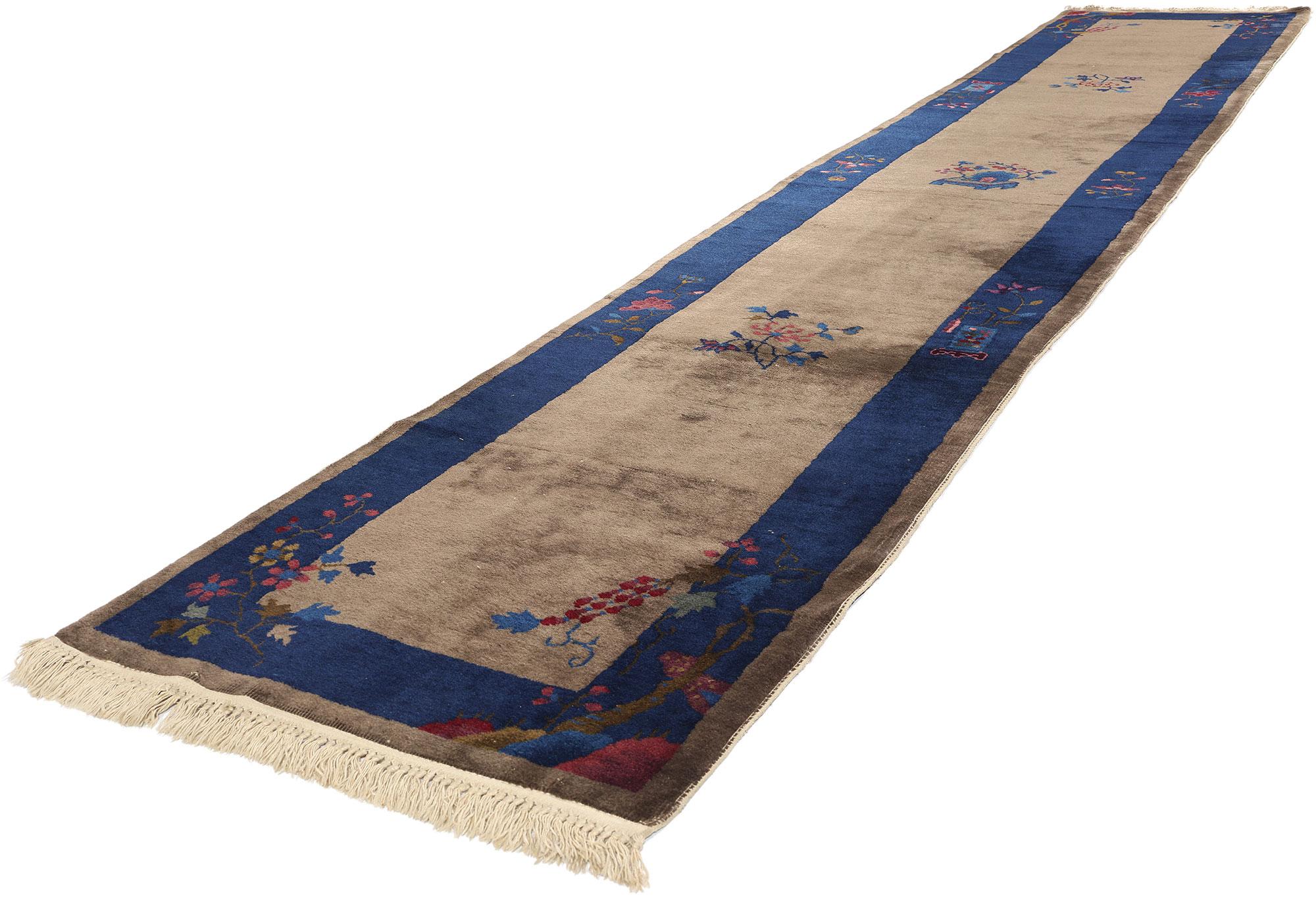78200 Antique Chinese Peking Rug Runner, 02'07 x 14'04. Behold the timeless allure of this meticulously hand-knotted wool antique Chinese Peking rug runner, where artistry and nature converge in a captivating dance of color and floral splendor. A
