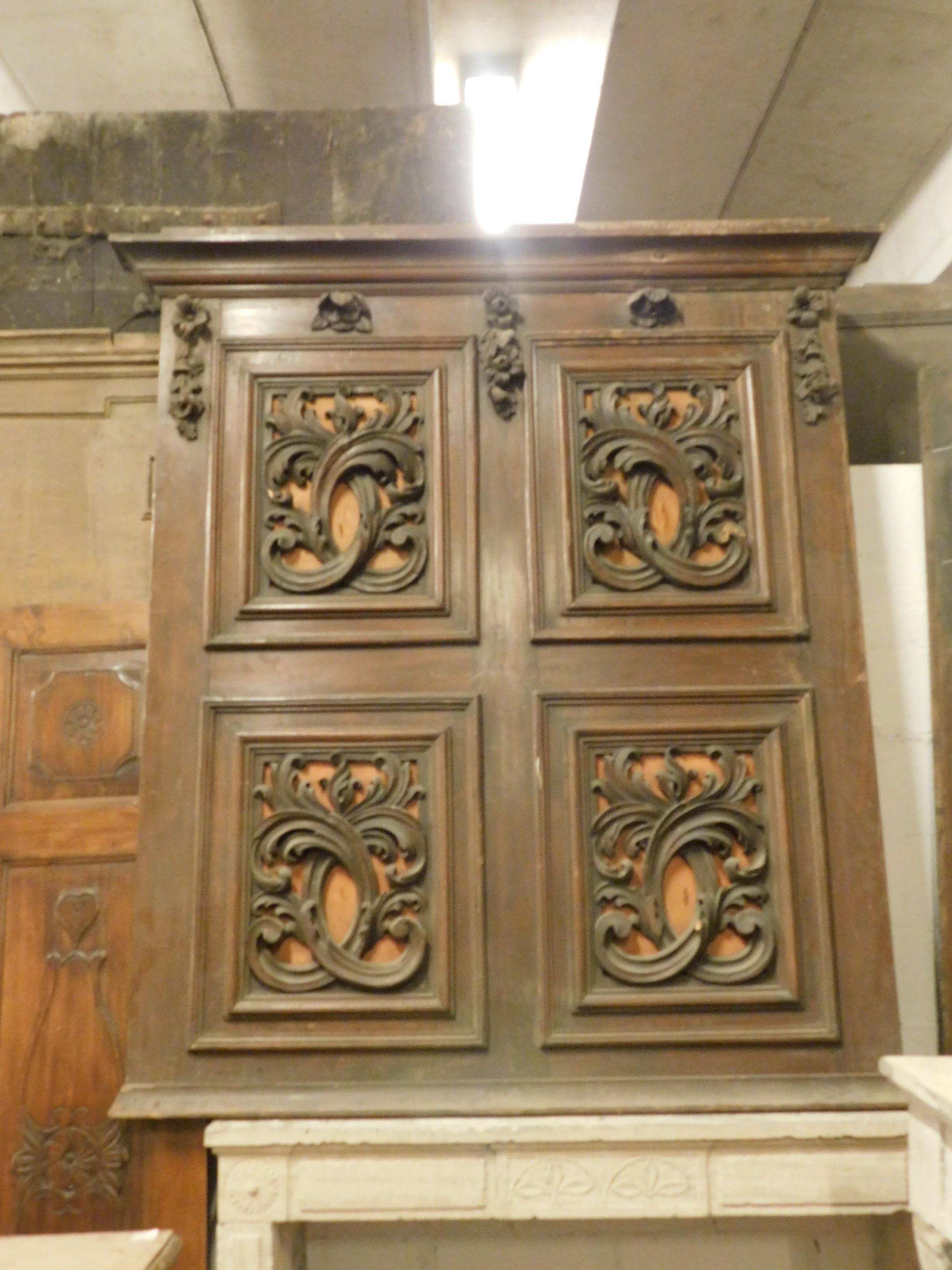 Antique brown and orange panel, ideal as a headboard or as a decoration panel, with 4 floral sculpted panels, orange lacquered bottom and dark brown wood very hand carved, with flowers and leaves moved. Coming from Italy, made in the 1900s.