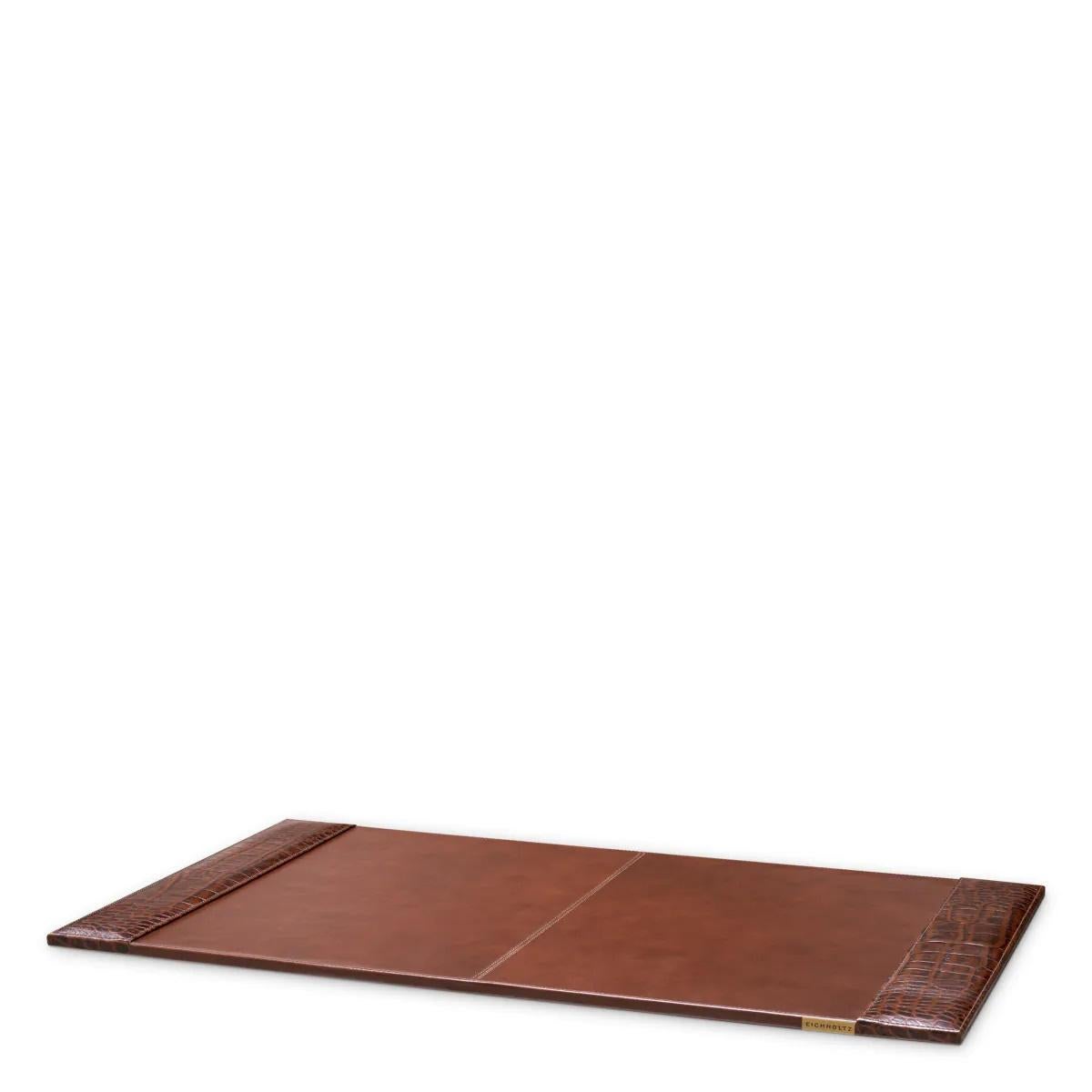 Antique brown crocodile-embossed leather desk pad.

Transform your workspace with this desk pad, where elegance meets functionality.
Crafted from brown leather with a striking crocodile embossed pattern, this elegant desk pad provides a refined