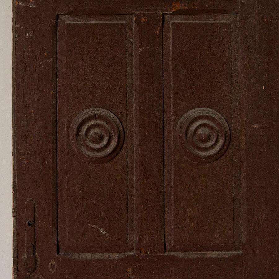 Unique vintage doors are a hot find these days to use as sliding interior doors. This one is special, with the carved, raised circular motif in the upper panel and diamond motif in the lower panel adding visual intrigue. This door is sold in as is