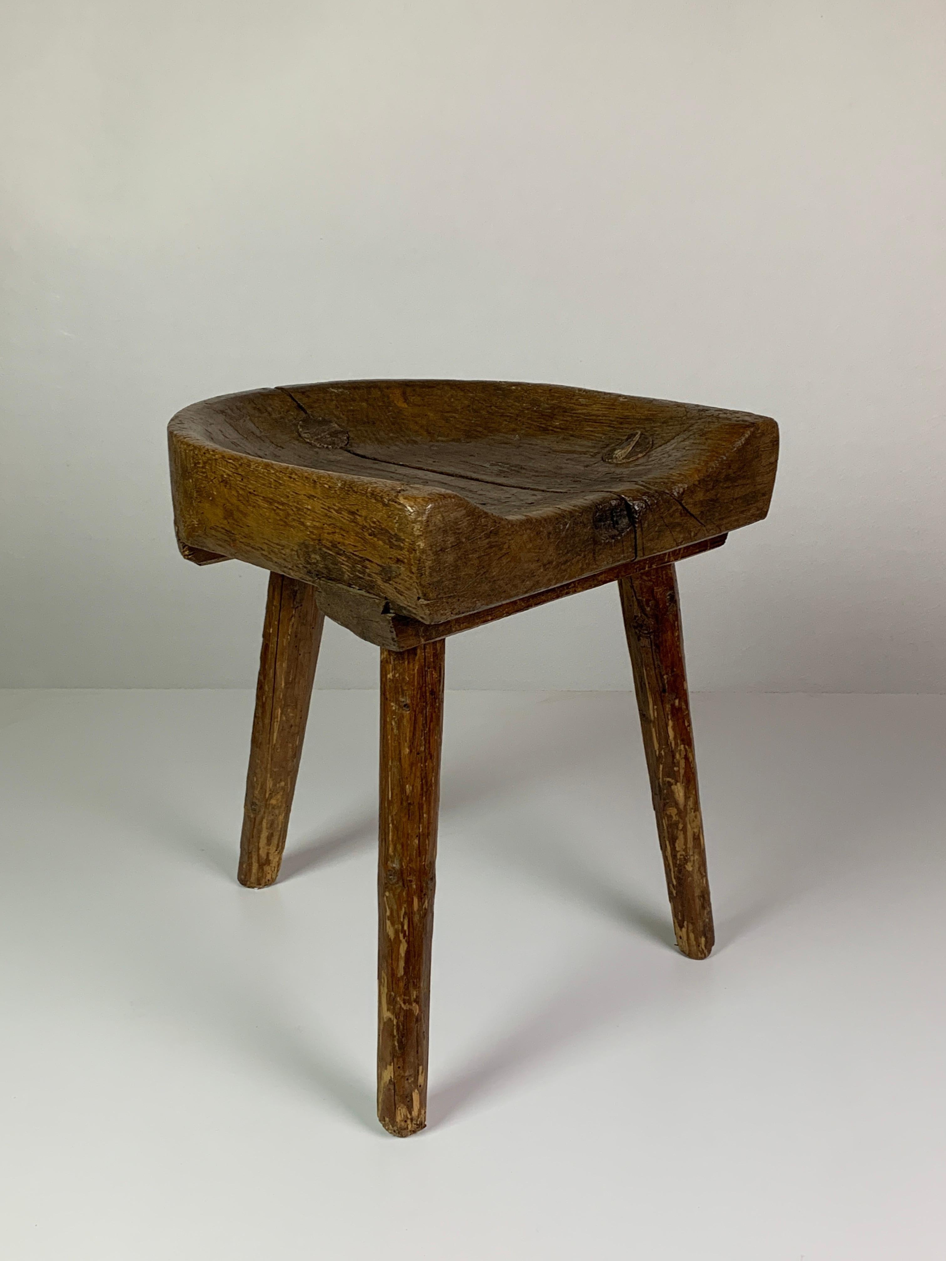 Absolutely stunning patinated oak tripod milking stool attributed to The Netherlands mid to late 19th century. This stool is in a lovely vintage condition, very sturdy but shows its wonderful age through wear and patination, a light paint spot which
