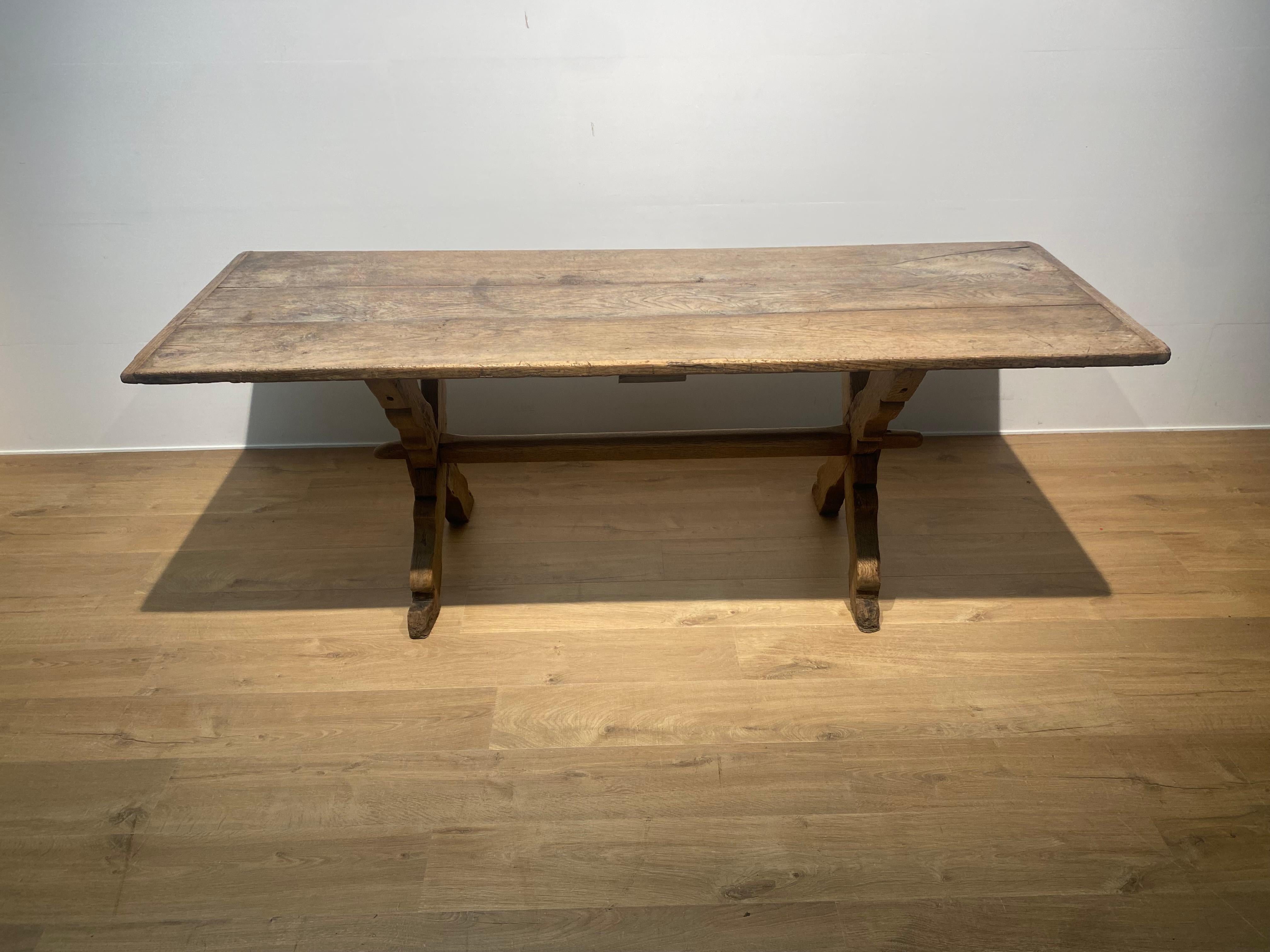 Elegant French antique table in a nice and warm bleached Oak,
sober and simple in its design,
3 parts table top on 2 x legs joined with a stretcher,
this table can be used as a kitchen table or as a dining table or as a desk