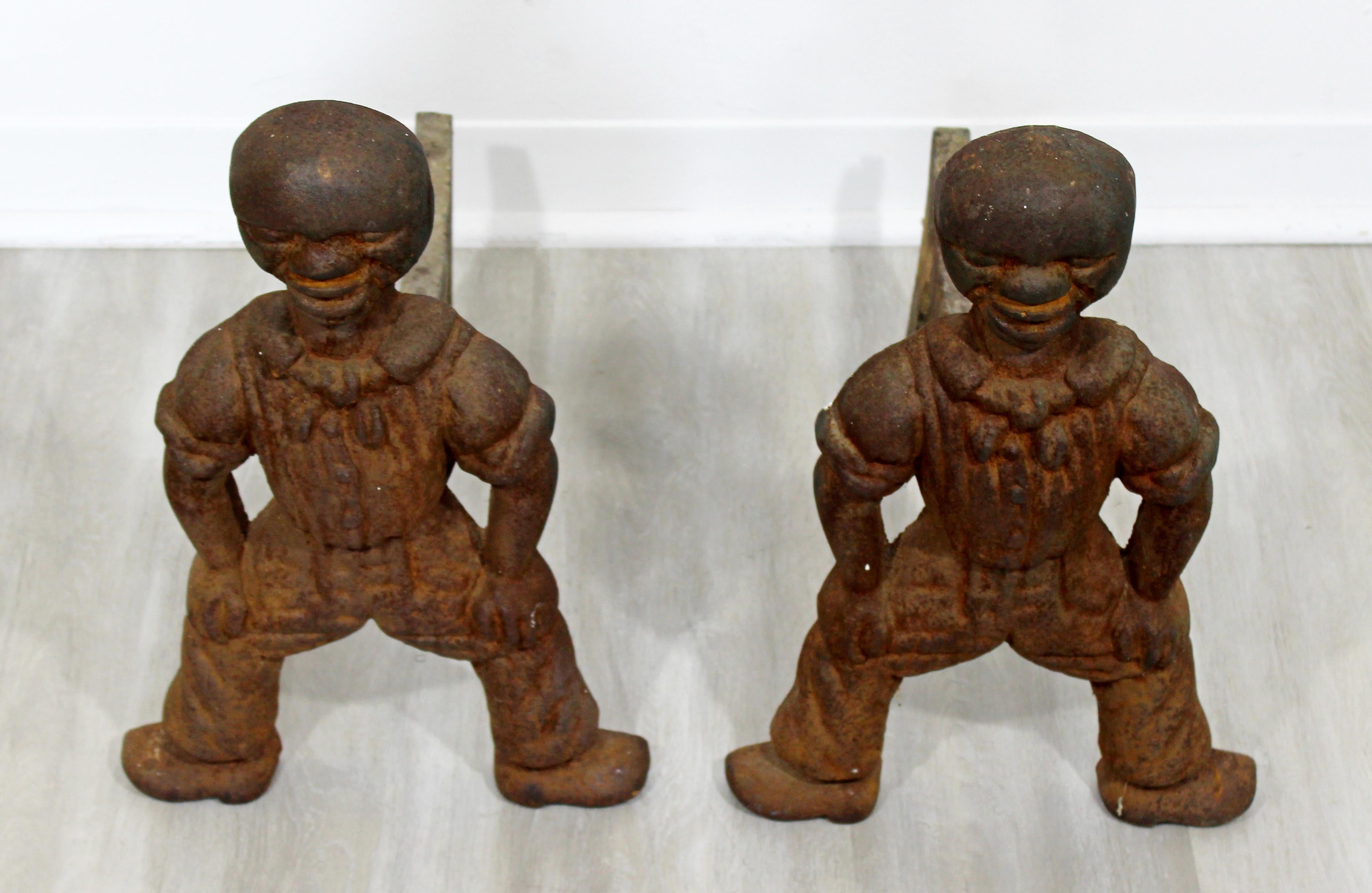For your consideration is an interesting pair of antique, Brutalist, African Art iron andirons, in the shape of figurines. In excellent condition, with age appropriate wear and patina. The dimensions of each are 12