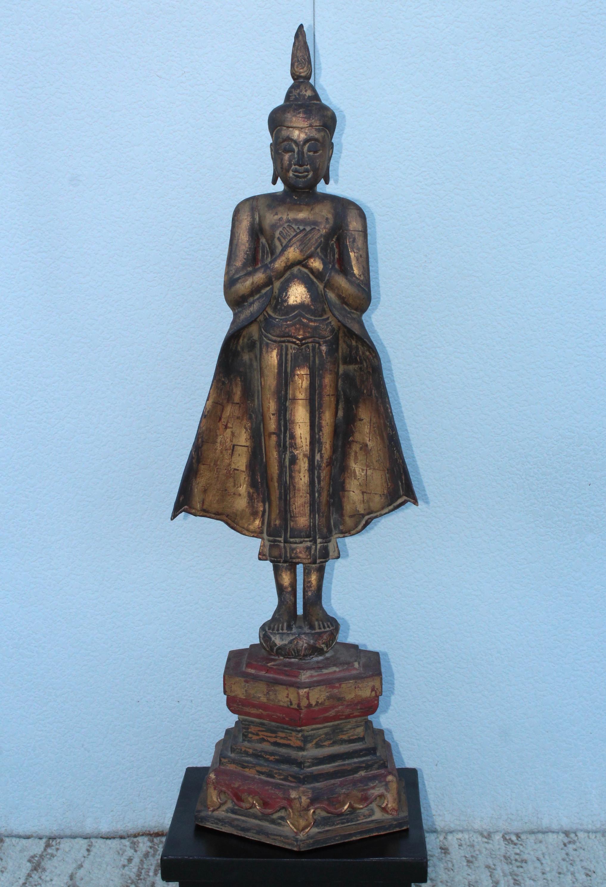 Stunning antique carved wood Buddha sculpture with gold leaf and paint finish. In vintage original condition with some due to age and use.